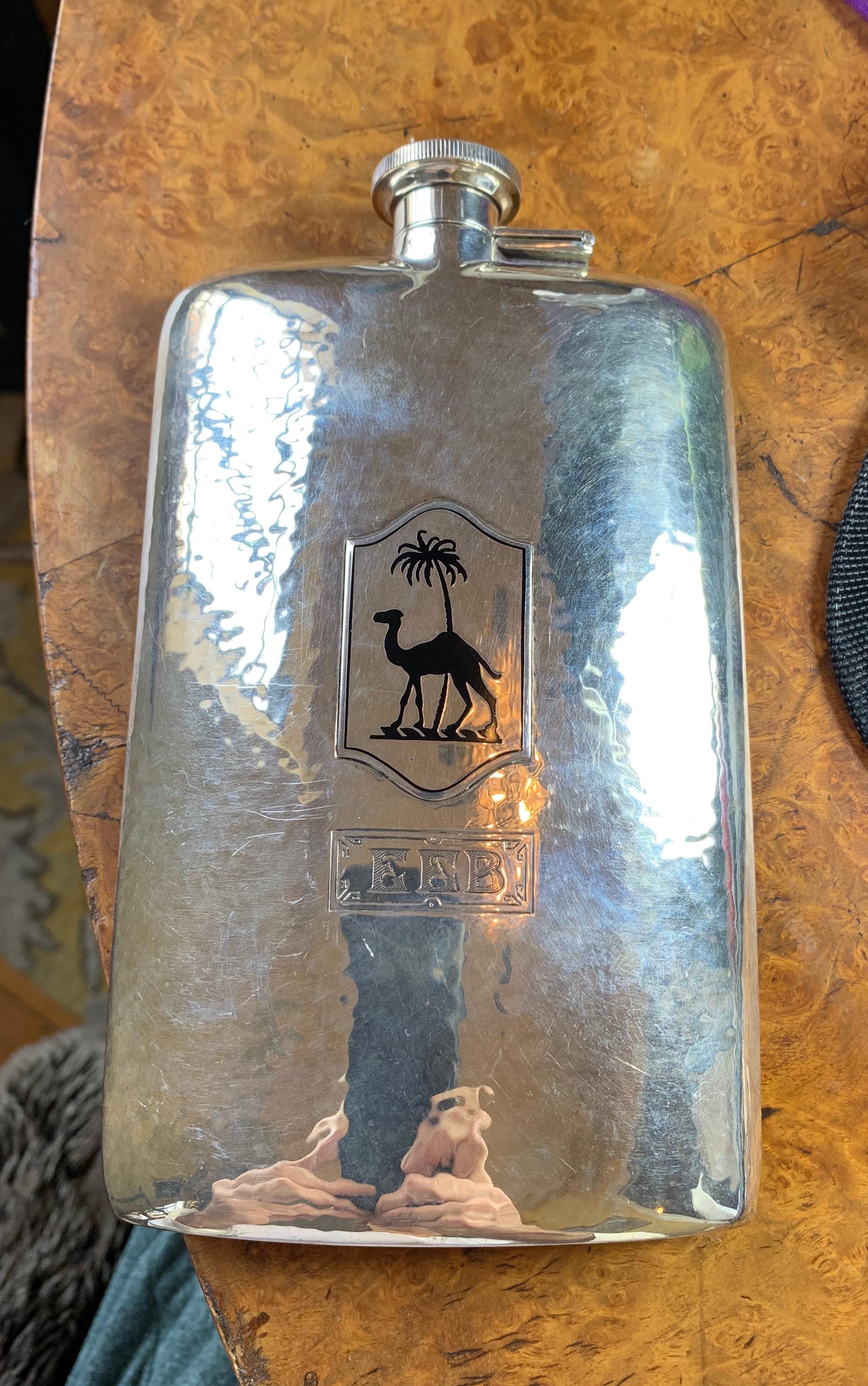 THIS IS A STUNNING AND RARE ART DECO LARGE SIZE POCKET FLASK IN STERLING SILVER AND ENAMEL WITH AN EGYPTIAN REVIVAL MOTIF OF A CAMEL AND PALM TREE.
This is a very special and rare pocket flask.  Flasks really do not get better than this.  The flask