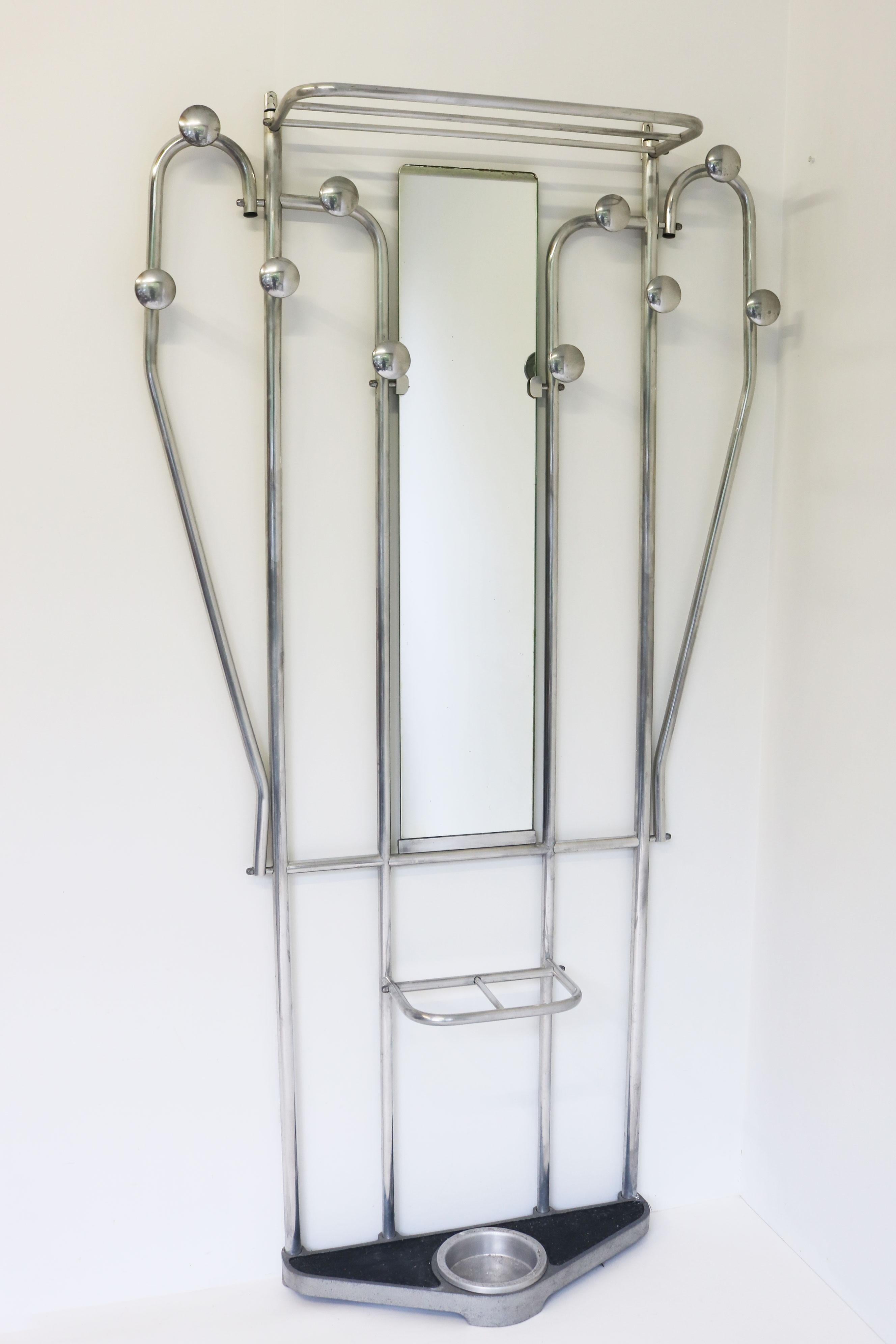 This Art Deco style hall tree hails from France, circa 1930s. It is crafted out of sleek, polish aluminum and functions as an umbrella stand, hat shelf, and coat rack. There is even a mirror in the centre, making this piece perfect for any entryway.