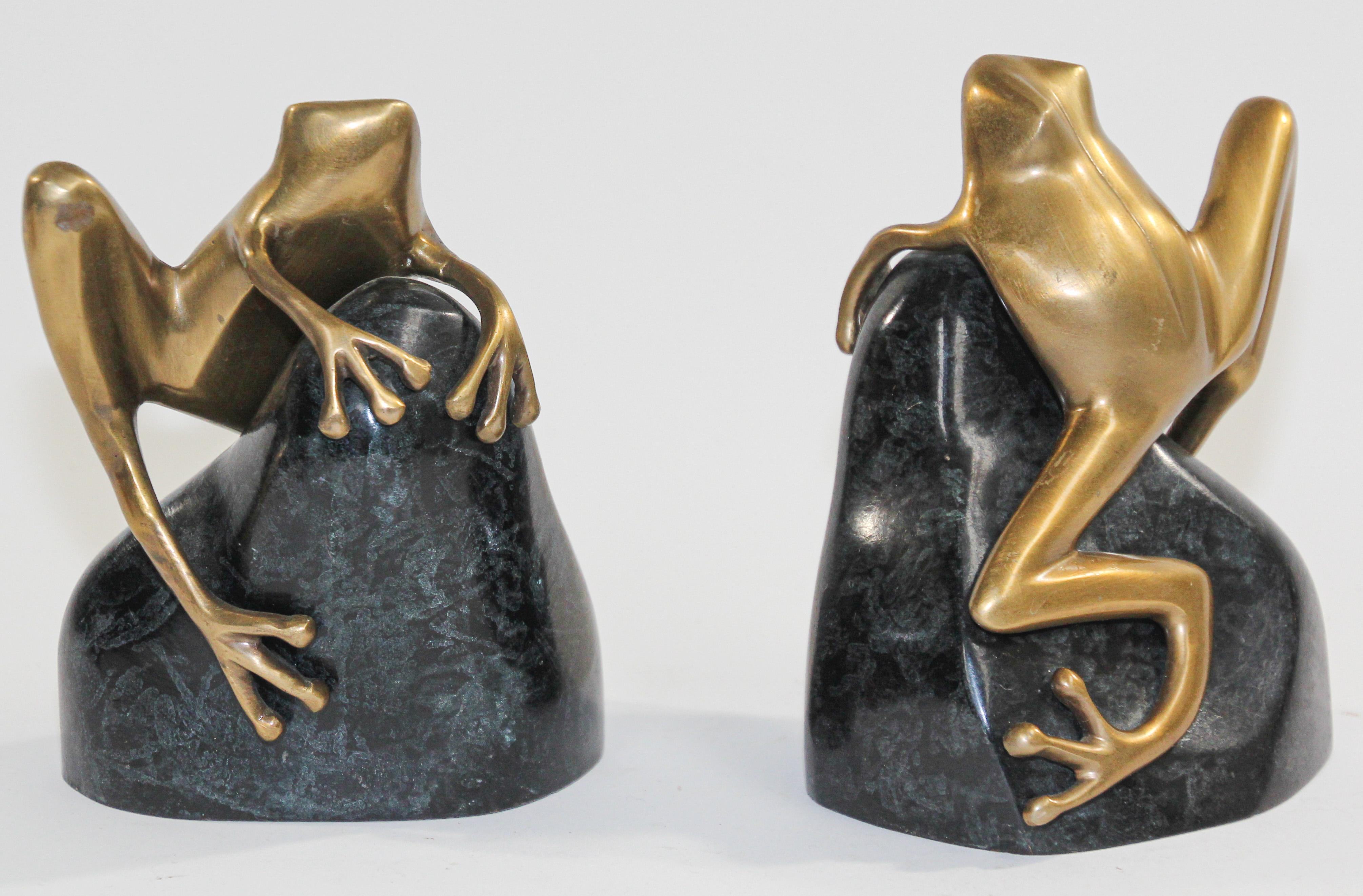 Pair of polished cast metal brass Art Deco style decorative frog bookends.
Set of unique heavy polished gold brass large frog sculptures on a green bronze patinated green rock.
Size for each is 6