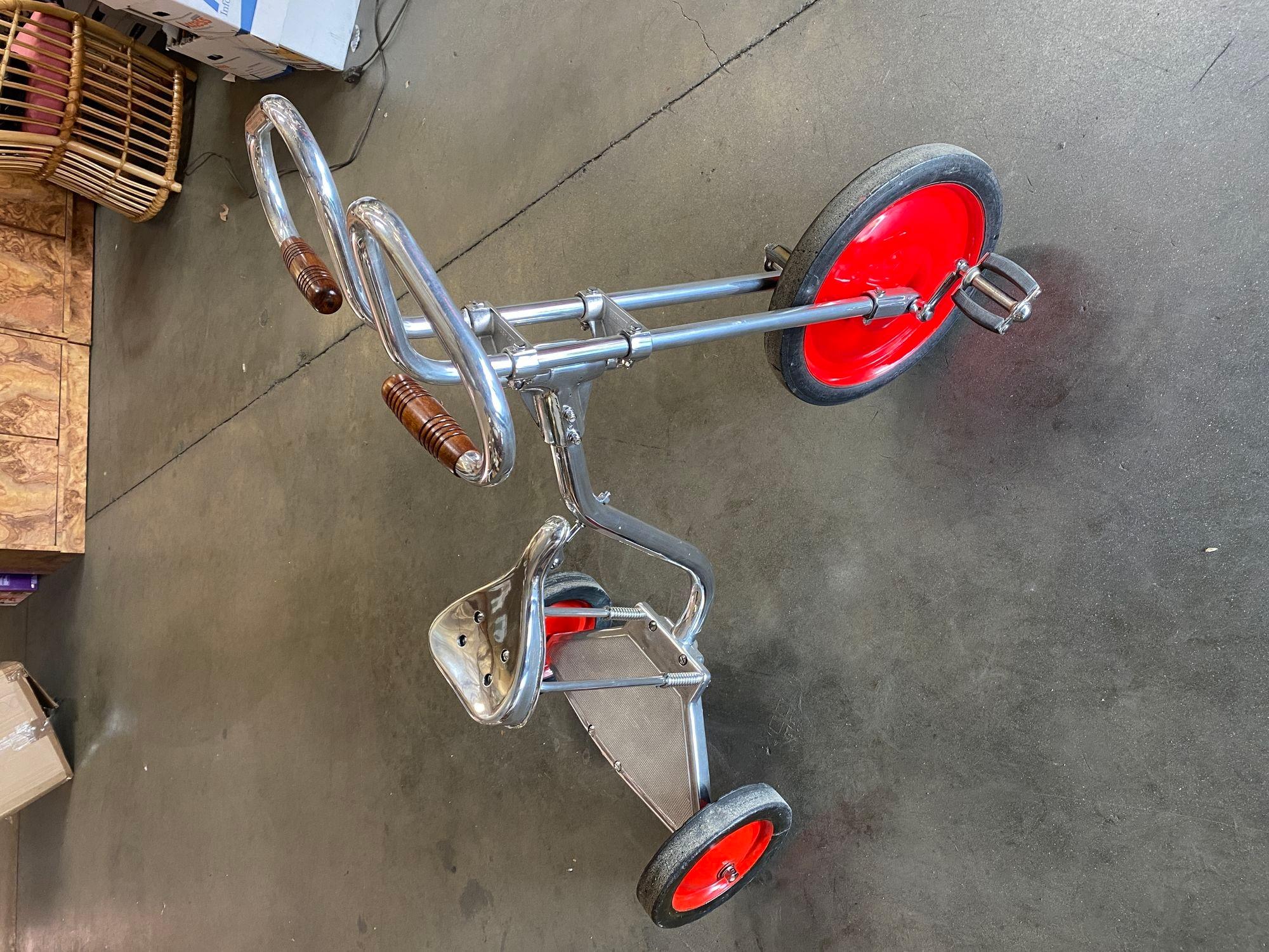 Circa 1940 is polished to chrome steel with walnut-finished handlebars in the style of Bowden Tricycle.
 
This large tricycle with easy fit a small adult 5' 6
