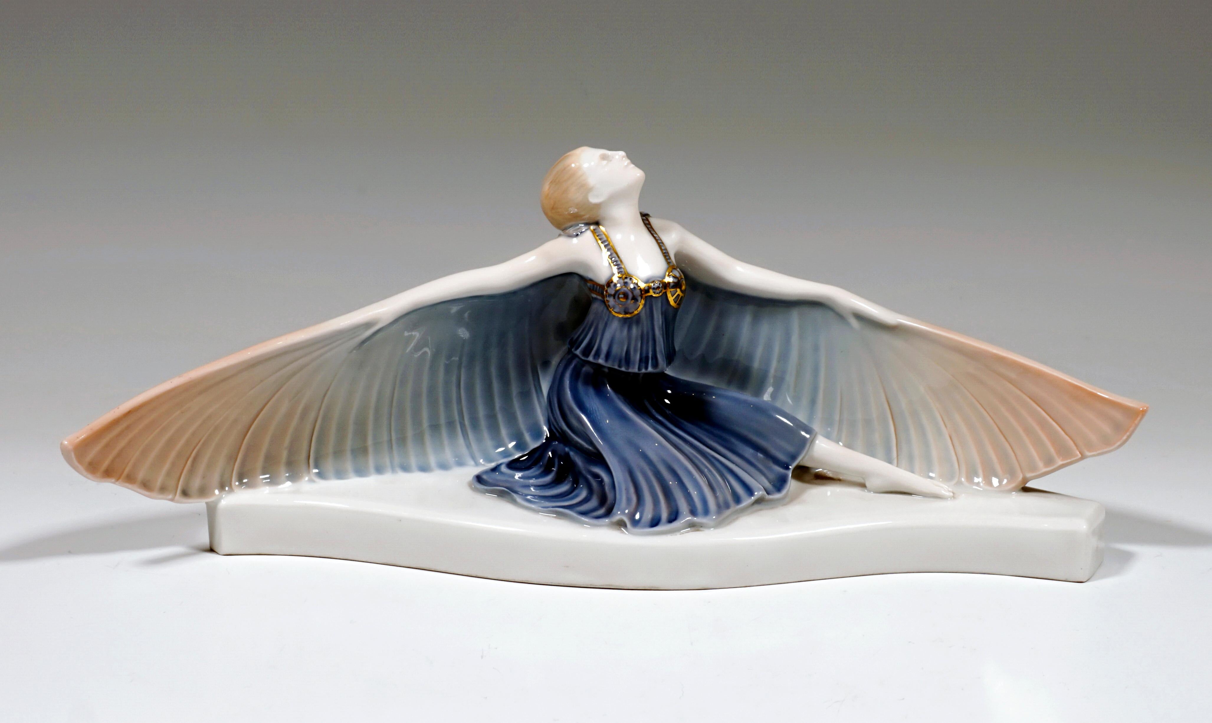 Kneeling dancer with head tilted backwards in a blue costume with a softly falling skirt and cape, and wide wings on the arms on a curved flat base.

Manufactory: Selb / Bavaria / Rosenthal Germany 
Dating: manufactured 1924
Material and