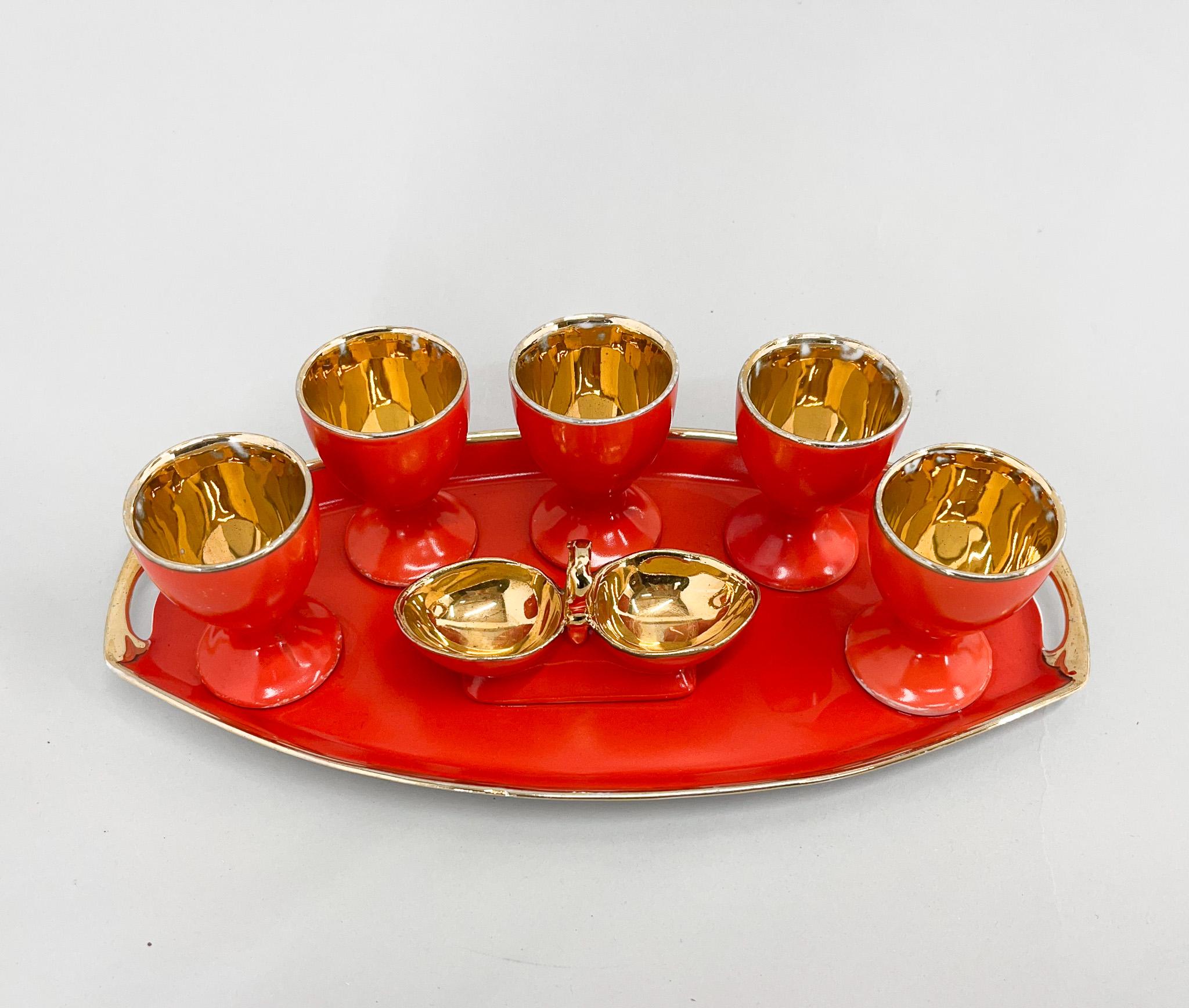 Art deco orange porcelain set of five egg cups, Artdeco complete porcelain set of five egg cups, salt and pepper little bowl and tray. All in orange colour, gilded.