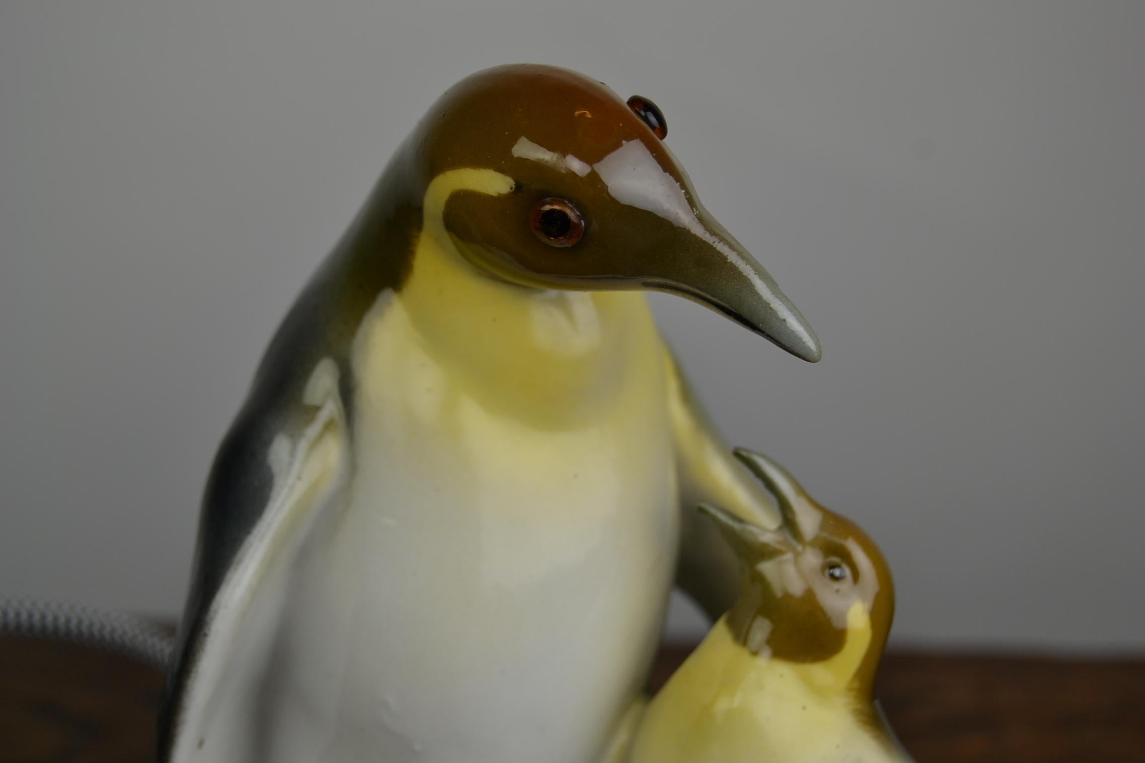 Art Deco Porcelain Perfume Lamp with 2 Penguin, a mama penguin and her young.
This porcelain animal sculpture - Animal table lamp dates was made by Ridem, Germany in the 1930s. This small table light is in working condition and has been rewired.