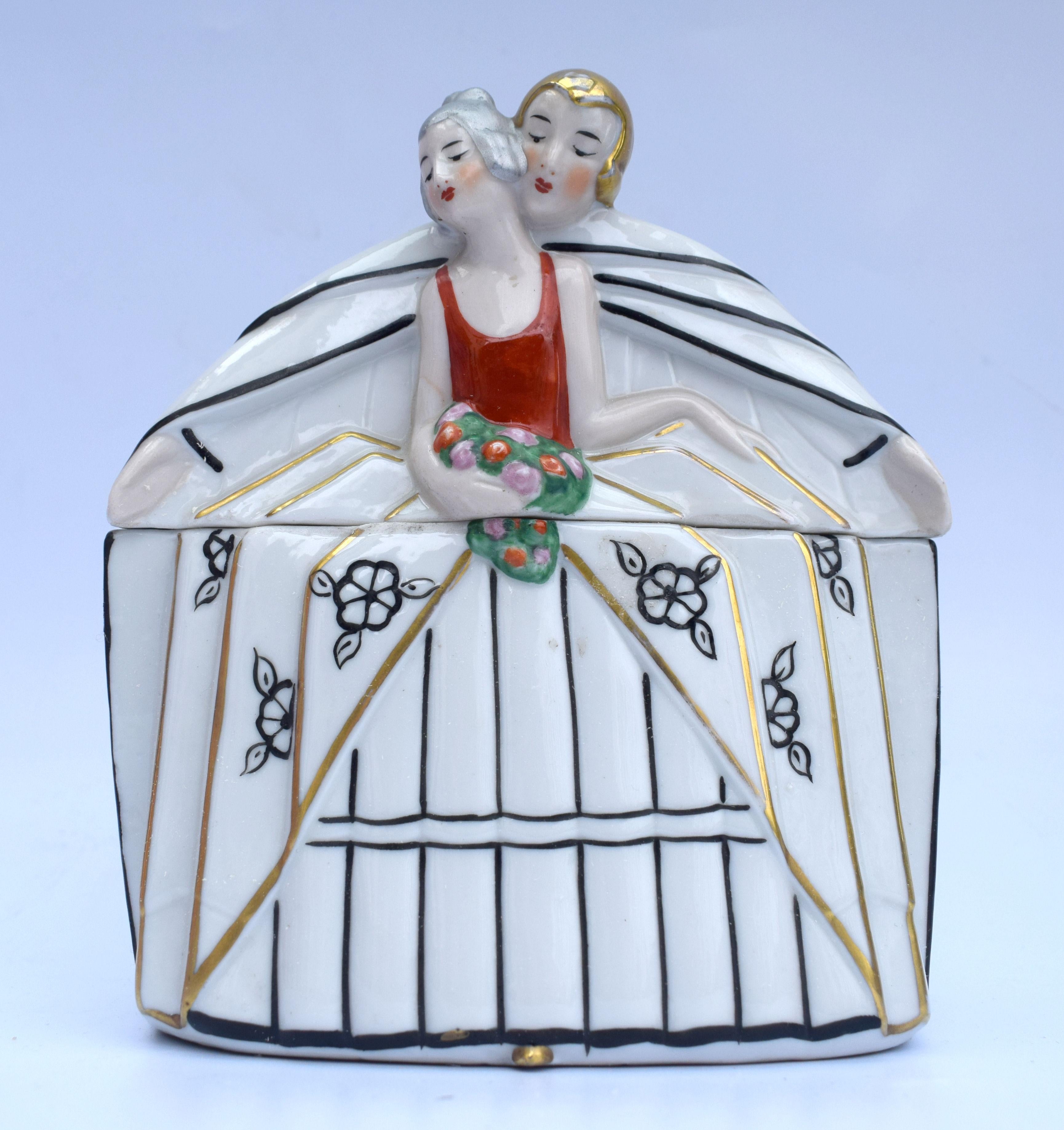 An exceptional Art Deco powder jar very desirable and would enhance any collection. The representation of a couple in love has been expertly hand painted, from the lightly blushed cheeks to the bouquet of flowers, this is a great example of Art