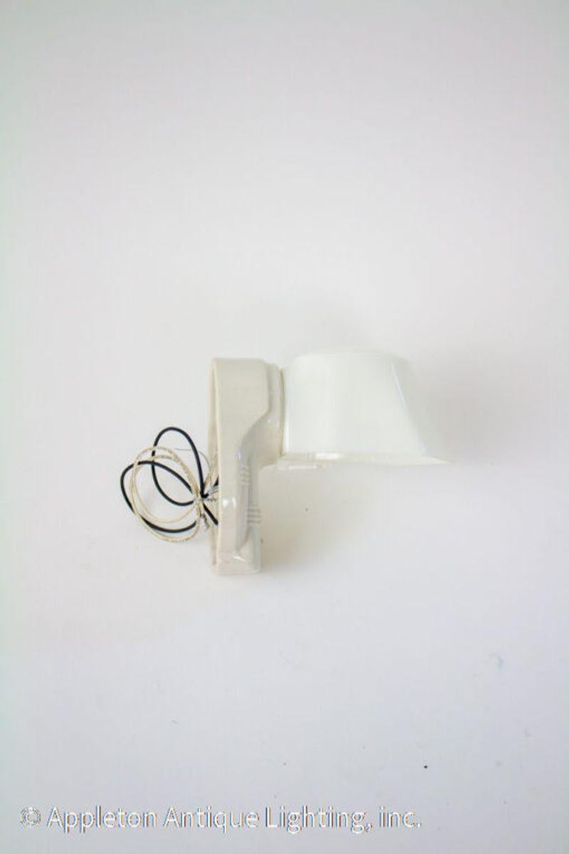 1930’s white porcelain sconce with original milk glass shade. Ideal for over a mirror in a small bathroom.

Material: Porcelain,Glass
Style: Art Deco,Traditional
Place of Origin: United States
Period Made: Mid 20th Century
Dimension: 5 × 7 × 7