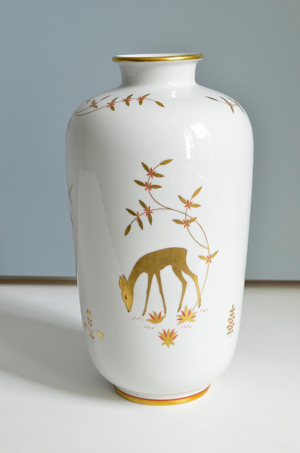 Art Deco porcelain vase by Greiner for Heinrich in Selb, Bavaria, Germany.
White and gold hand painted vase with deer and owl decor, 1940s.
    