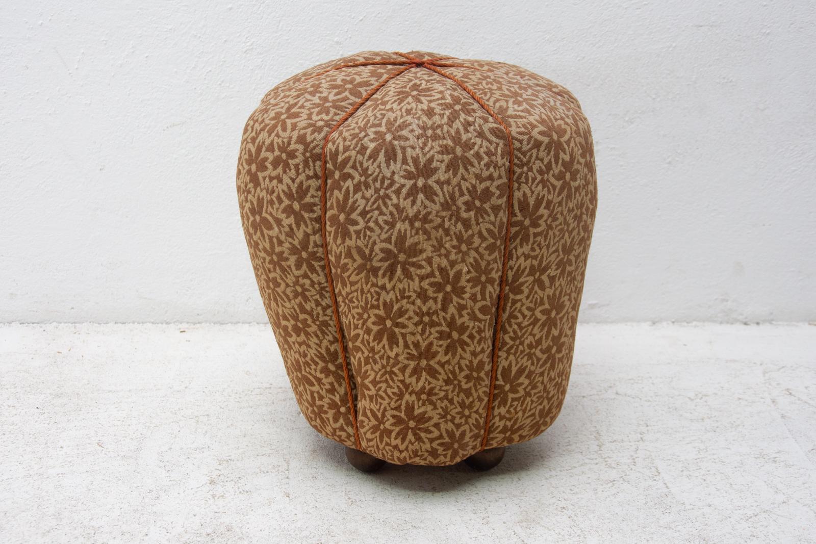 This pouffe(footstool) was designed by Jindrich Halabala and produced by UP Závody in the 1950s. Very comfortable retro chic in the shape of a raspberry. The upholstery is in good condition, the stool has slightly protruding springs in the seating