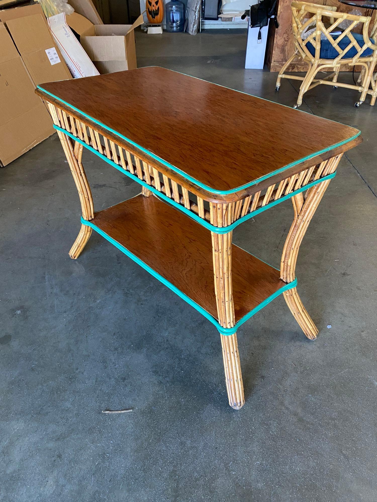 Circa 1940 6-tier rattan shelf/console table with mahogany shelving and tabletop. This small shelf doubles as a shelf and a console table, perfect for use as a focal point in a living room, lobby or hallway.
 
Could also be used as a TV stand with