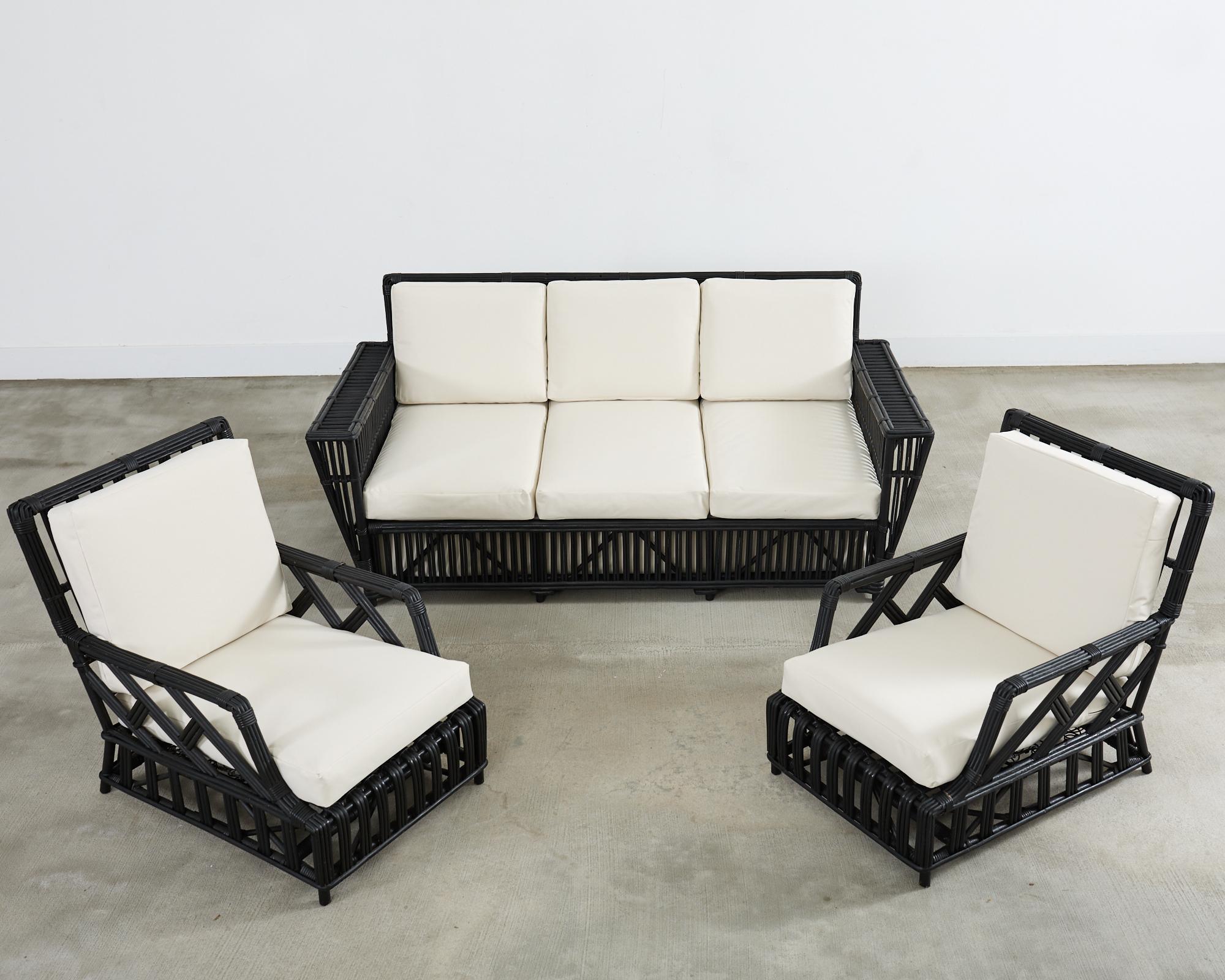 Dramatic living room set consisting of a President's sofa and a pair of President's lounge chairs named after FDR's rattan furniture aboard the USS Potomac. The seating is crafted from rattan and stick wicker with each seat having a supportive steel