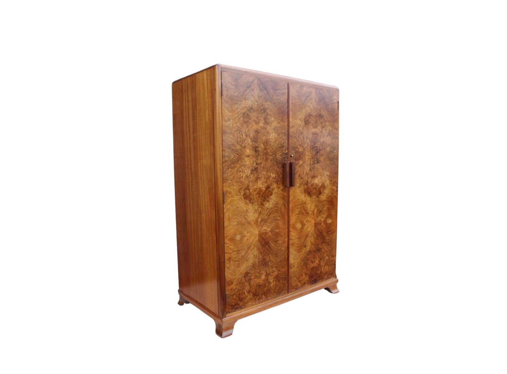 A beautiful extremely useful Art Deco press cupboard by the furniture manufacturers Vesper, dating to Circa 1930. This gorgeous piece has highly figured burr walnut doors and top with straight grain walnut sides all in a fabulous rich conker colour