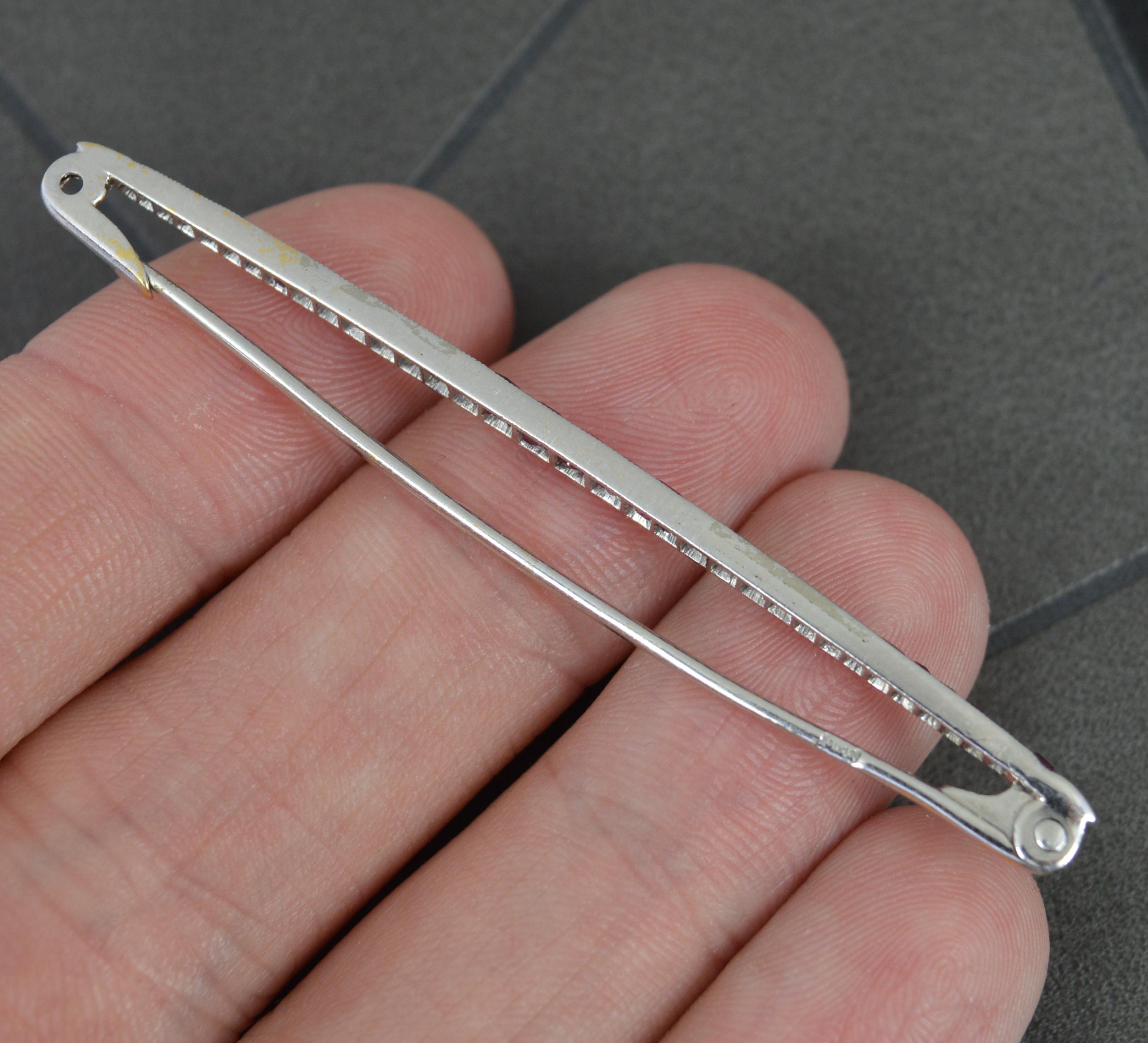 A stunning Art Deco period bar brooch. Circa 1930.
Solid 18 carat white gold example with a fine platinum setting.
Designed with alternating sections of princess cut ruby stones and rose cut diamonds.

CONDITION ; Very good. Securely set stones.