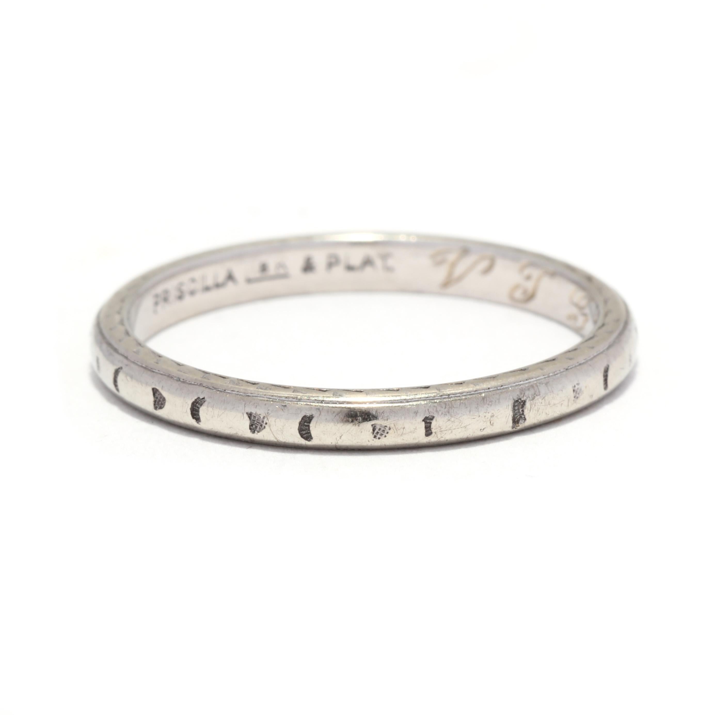 An Art Deco Priscilla platinum and 18 karat white gold engraved wedding band. This stackable band features a slightly domed design with an engraved arrow motif on the outside and with 'VTG to MFE OCT 20 29' engraved on the inner band.

Ring Size