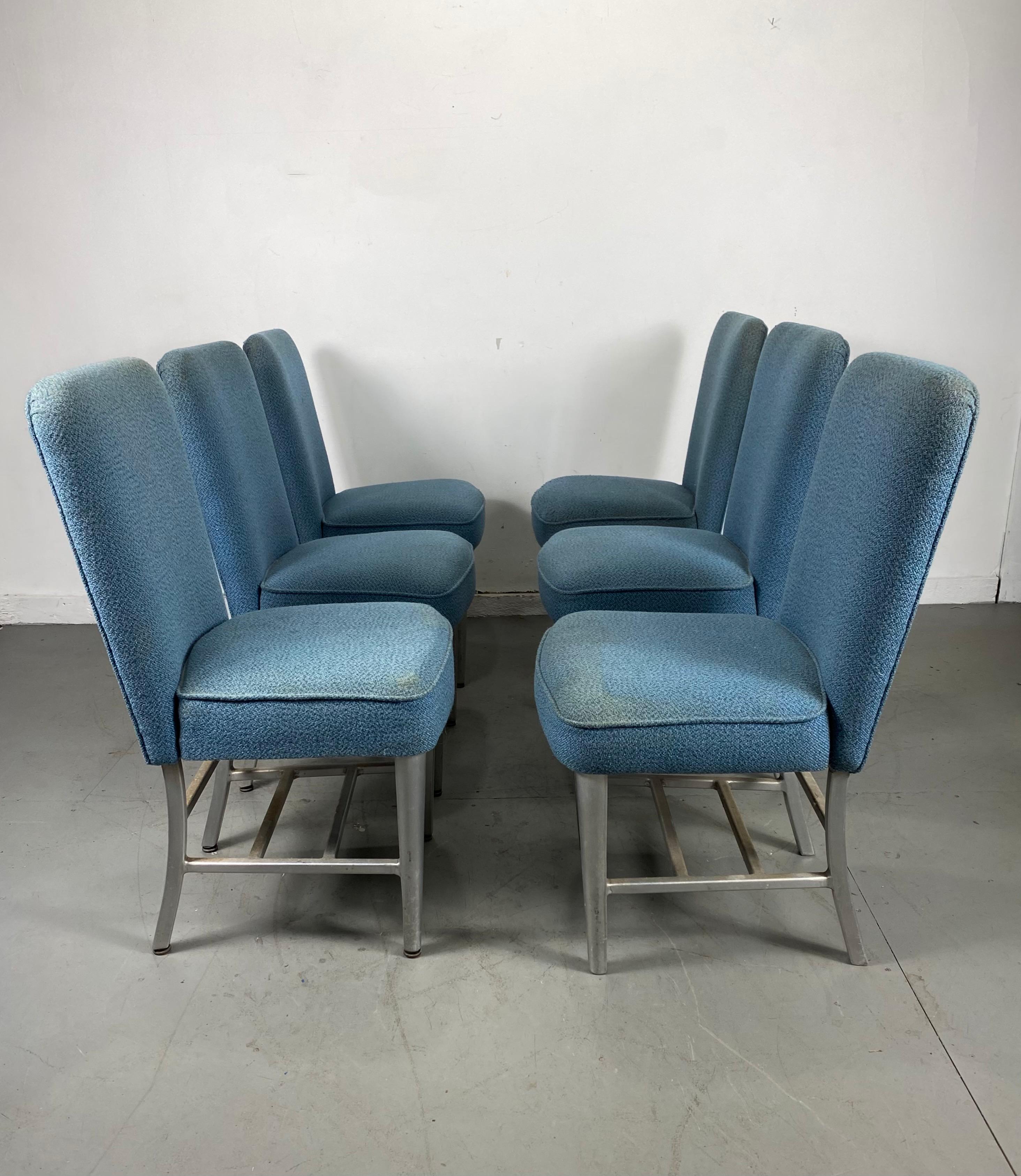 These Art Deco aluminum dining car chairs were salvaged from a Pullman passenger train remodeled in the 1960s. The chairs feature tubular aluminum frames and blue wool upholstery, fabric in need of cleaning.

Attributed to Emeco.