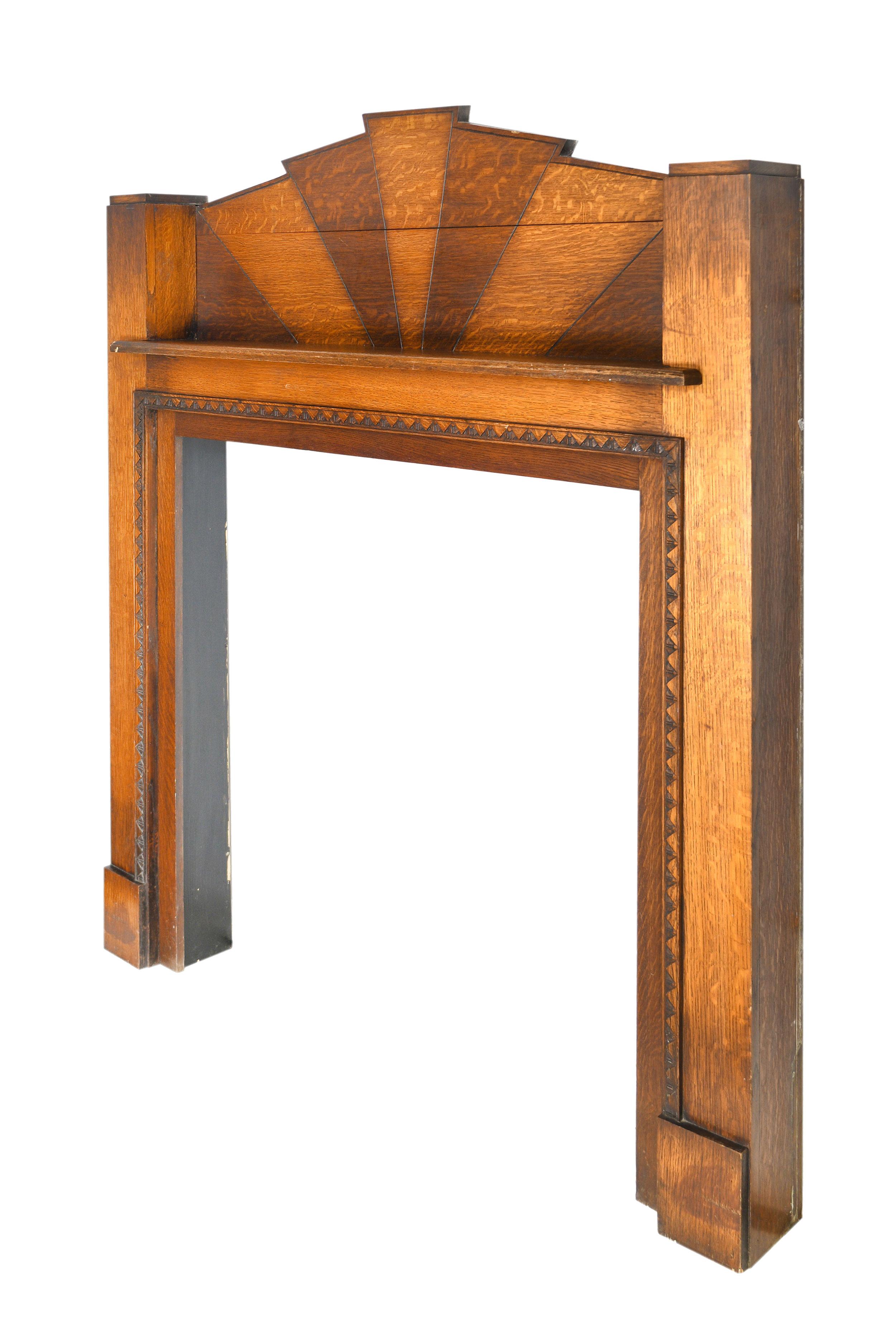 The small stature of this Art Deco mantel doesn’t make it any less of a show-stopper. The sun burst design coming out from the top shows the texture in the grain of the two tones of wood. Your eyes can’t help but move about every surface. The simple