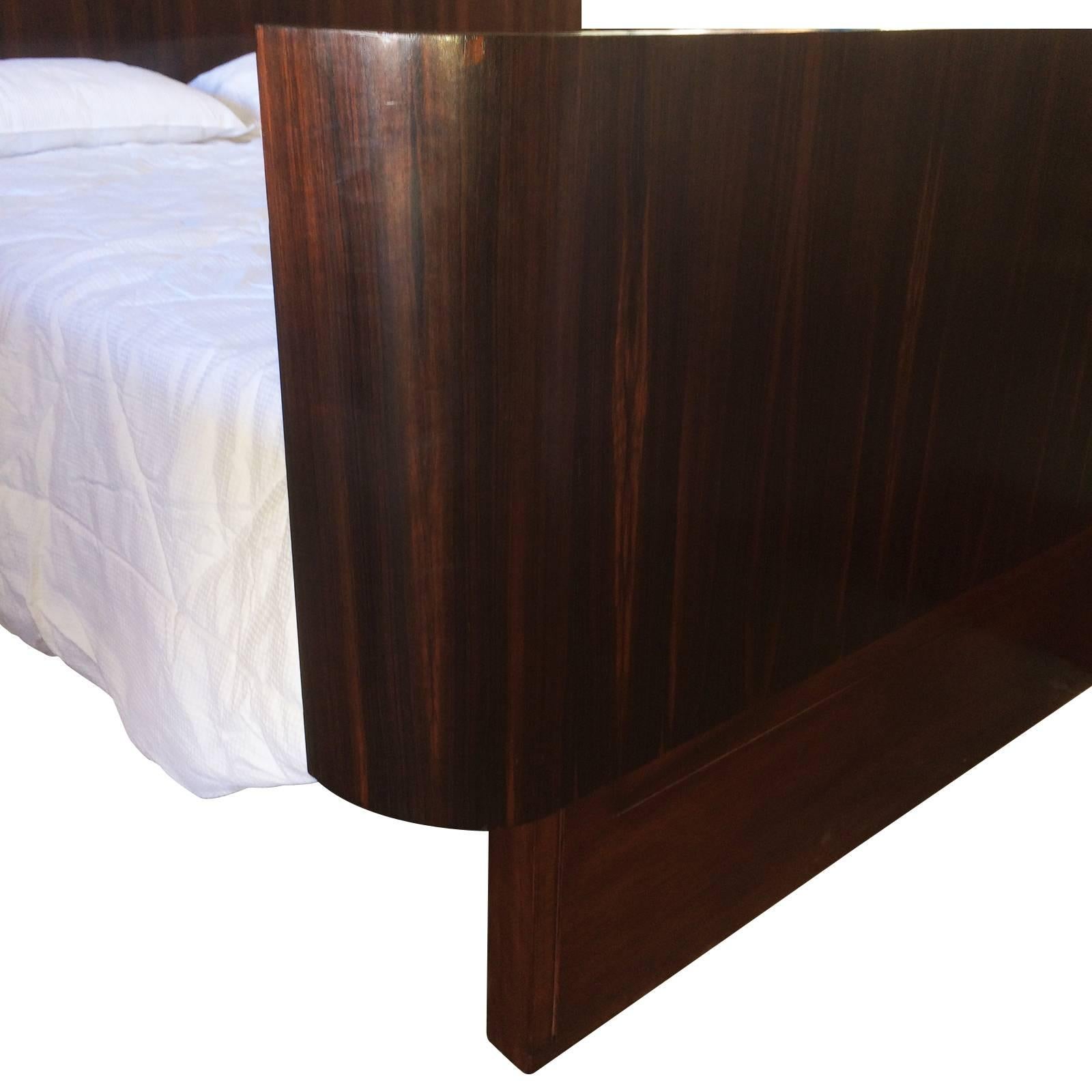 Art Deco Majorelle queen-size Bed in stunning French Macassar wood displaying the grain vertically with the veneer repeatedly mirror imaged over all surfaces and edges. The Majorelle Insignia is branded to a discreet rear area of the head.
The