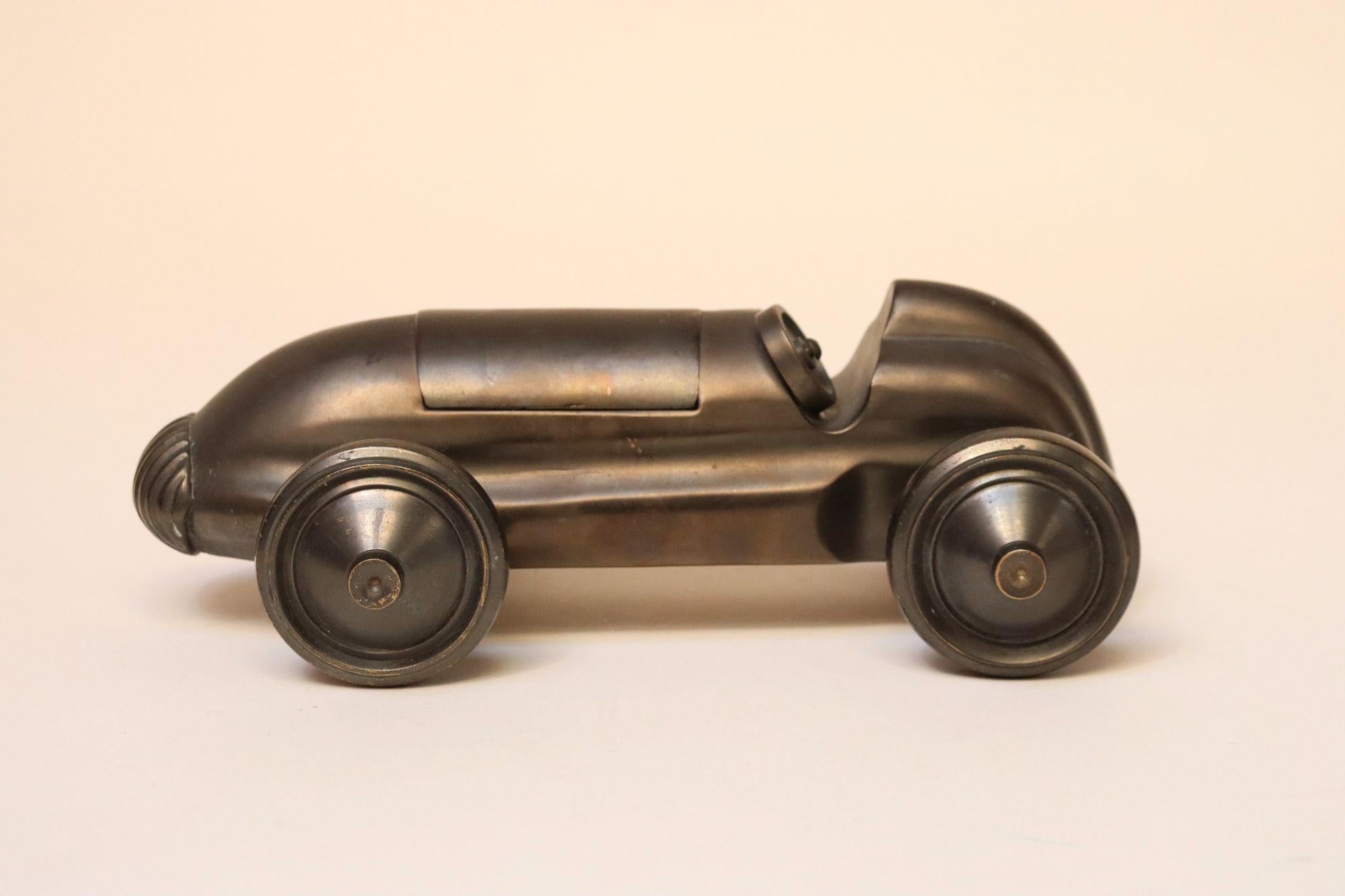 Figurine de voiture de course/roadster en bronze coulé Art déco ressemblant au bolide popularisé par la pièce du jeu Monopoly de 1935 (vers les années 1930, États-Unis).
Objet décoratif attrayant et polyvalent pouvant servir de presse-papier ou
