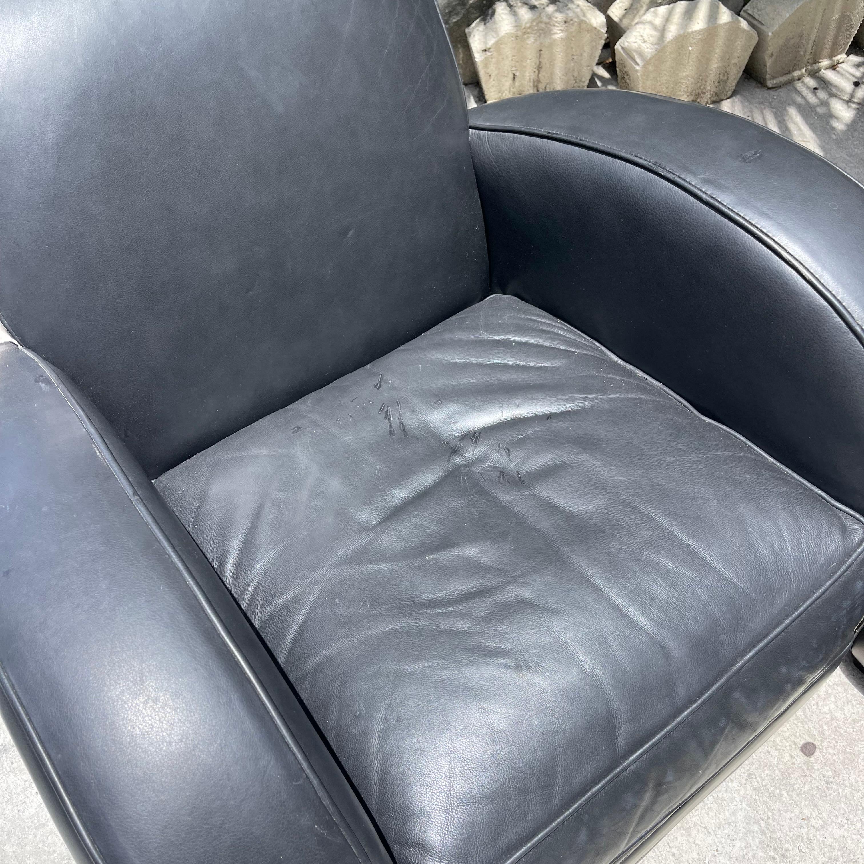 Fabulous pair of leather lounge chair in a classic streamline deco shape.