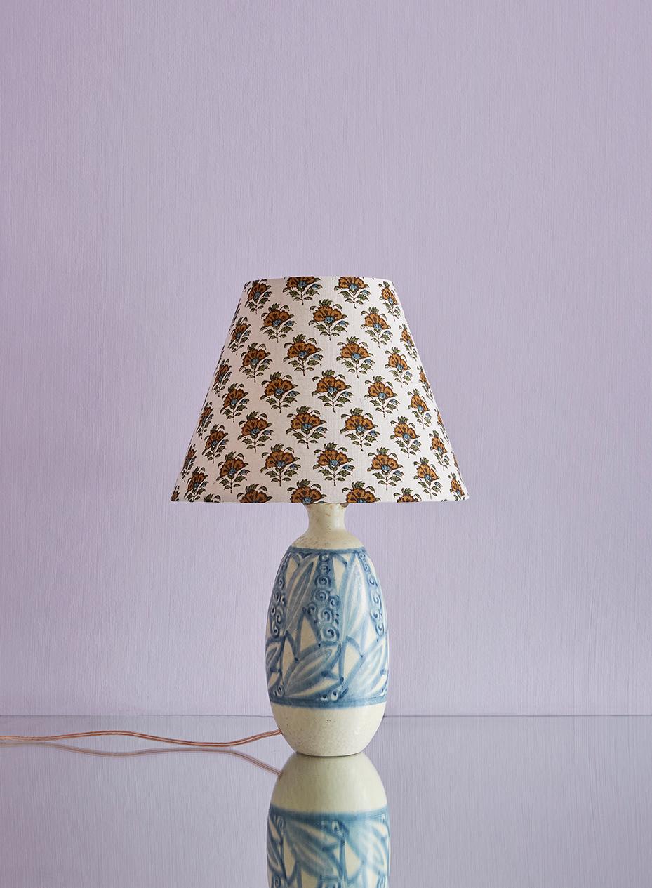 Beautiful vintage ceramic lamp base by renowned French ceramicist, Raoul Lachenal (1885-1956), paired with a customized floral lampshade. The lamp base is of a pure Art Deco style and period, in handmade quality with decorative blue and creamy white