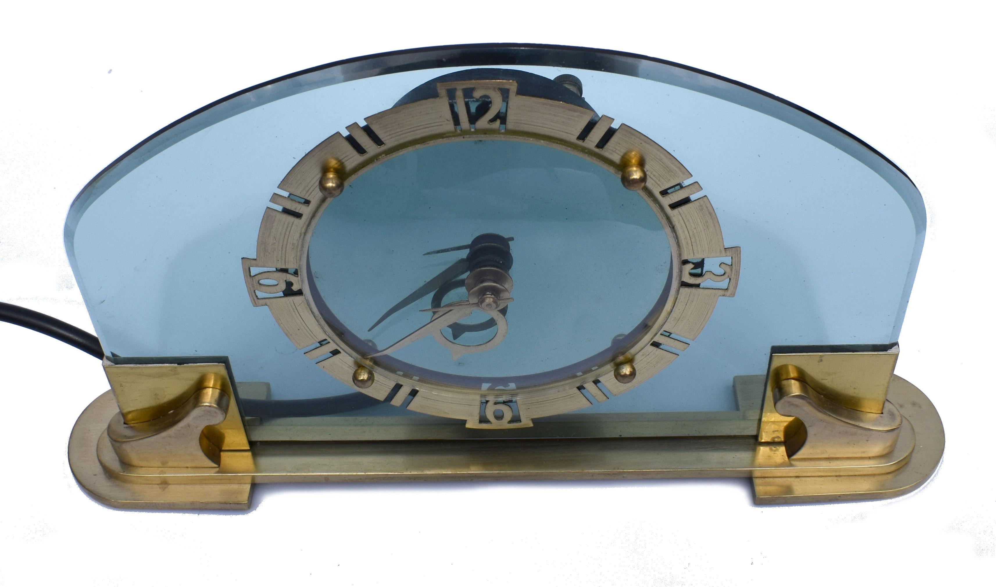 Large and rare and stunning BEM LTD Art Deco glass, brass Electric Mantle clock. This clock is an absolute delight. This glamourous clock features a brass bezel with fretted out numerals and a turquoise colored glass dial. The clock as with all our