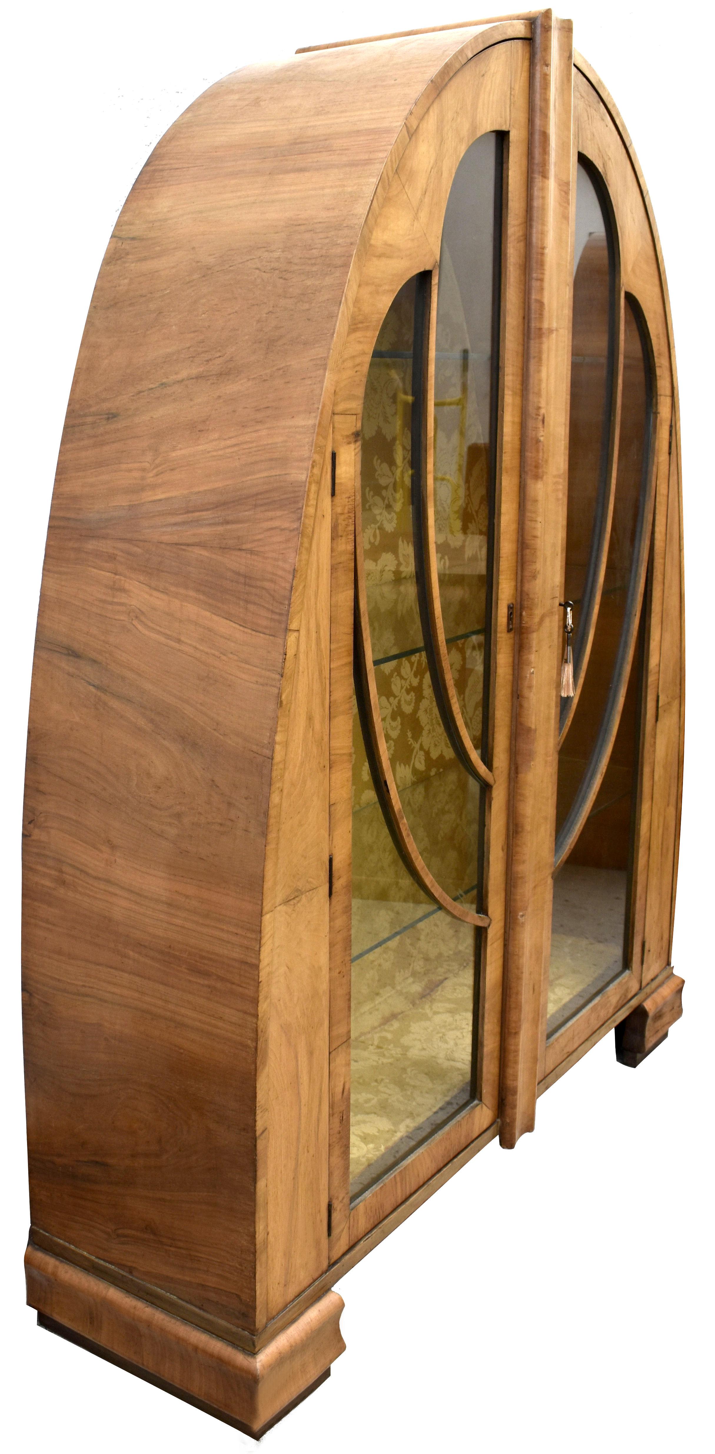 For your consideration is this rare and totally original 1930s Art Deco English walnut display cabinet. A gorgeous piece of furniture that's veneered in figured mid tone walnut with astragal glazed doors. Still retains its original silk interior