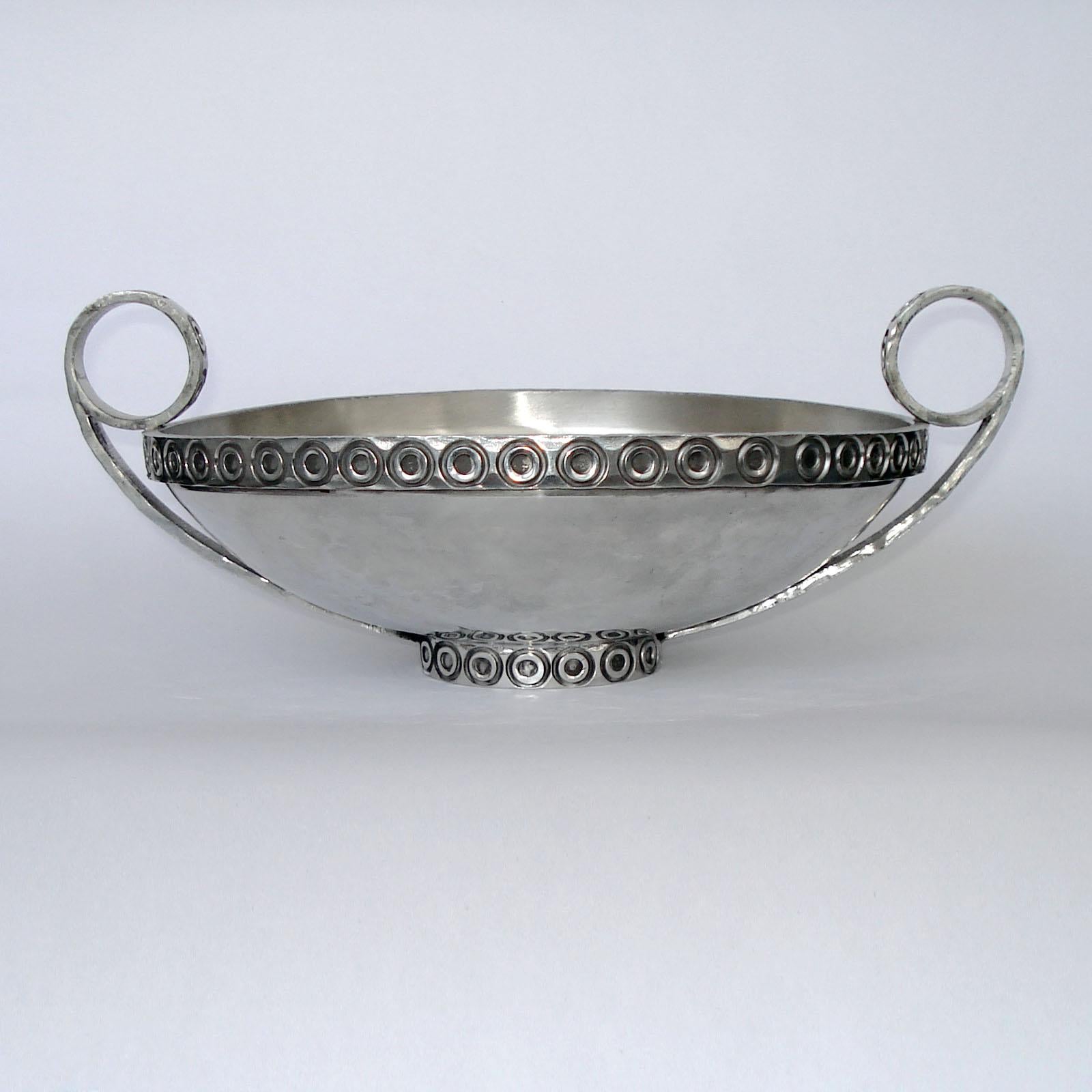 Norwegian Scandinavian mid century hand made pewter bowl. An extraordinary piece of workmanship and a piece of art itself. Realized in hammered technique, handles, rim and bottom decorated with circles 