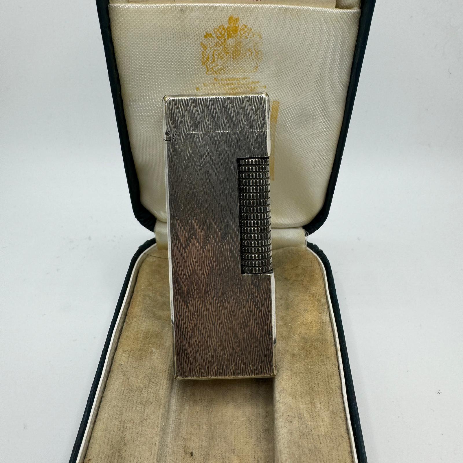 Rare Iconic Vintage and Elegant Dunhill Silver Plated 
Circa 1970s
Swiss Made Lighter
The James Bond lighter of choice 
Art Deco 
In mint condition.
Works perfectly. 
Iconic and beautifully engineered piece in rare condition.
In original BRITISH