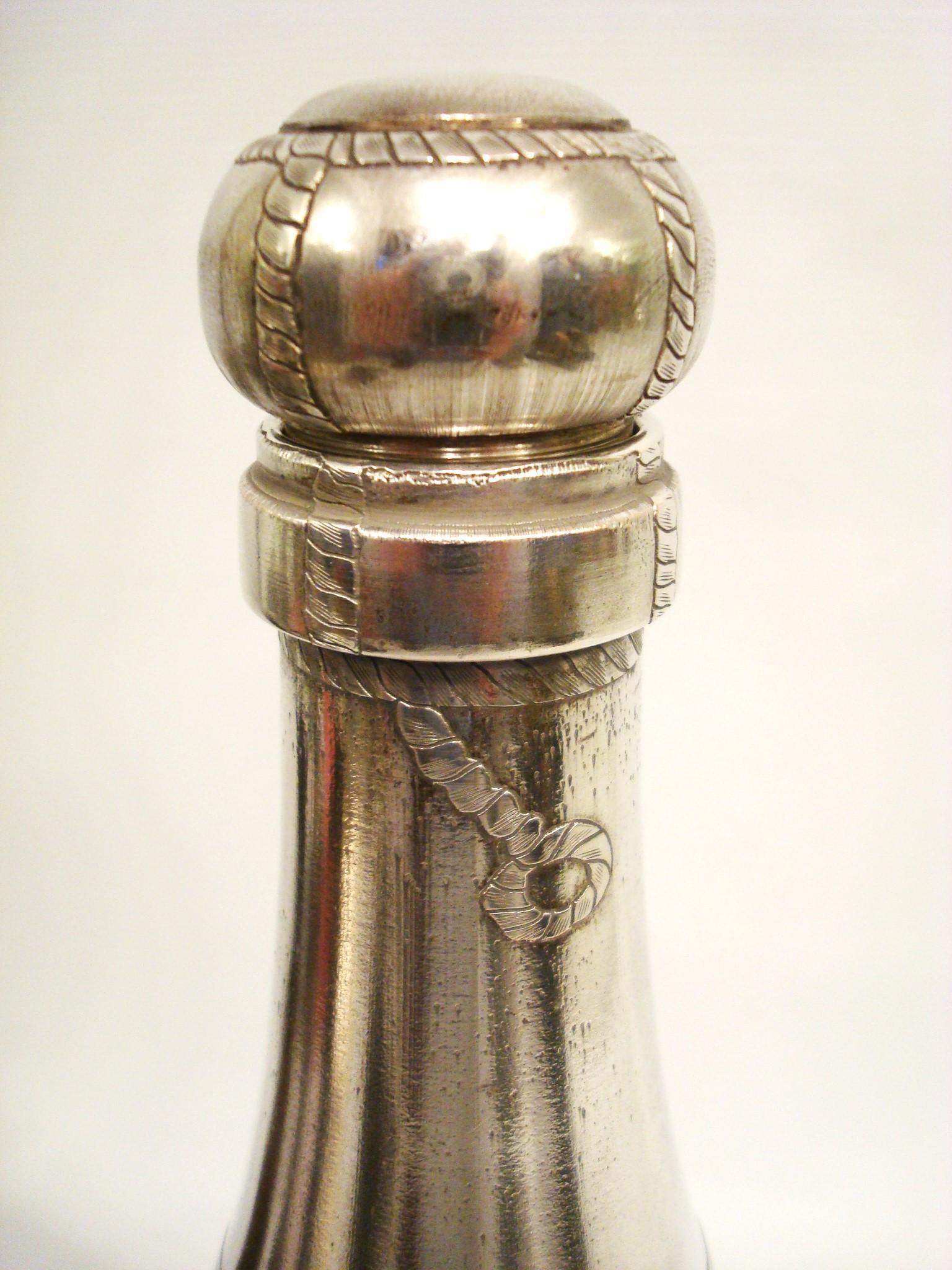 Art Deco Rare Silvered Champagne Bottle Cocktail Shaker. France 1930´s.

A rare silver plated Champagne bottle cocktail shaker with engraved label, foil and cork wire detail. The Shaker separates in just below the shoulder to fill with ice and