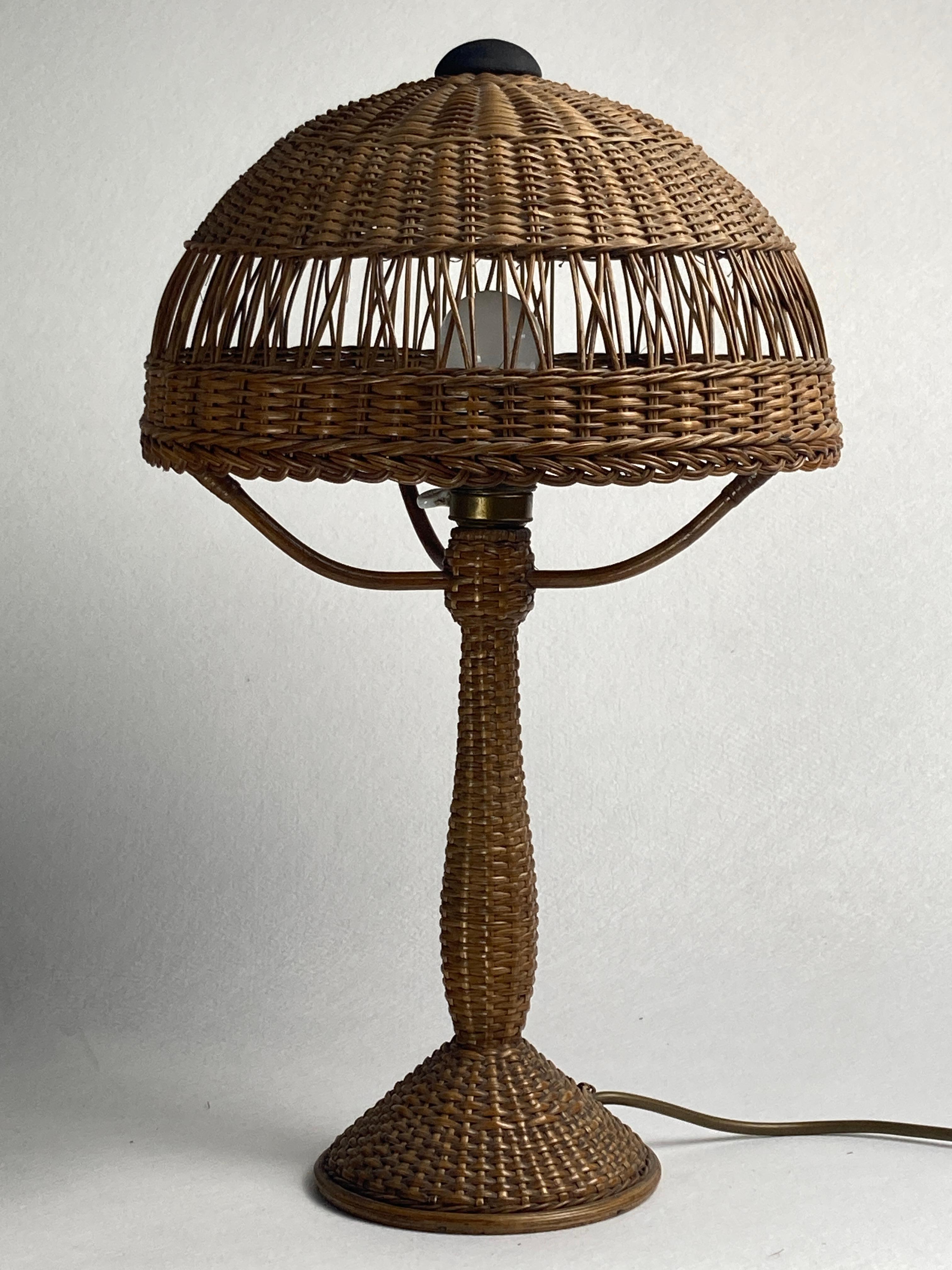 Absolutely stunning rattan wicker table lamp from the 1930s-1950s. The lamp came with an attribution to austria which we have left out of the title as we have never seen a similar model. The lamp is in great condition considering its age with only