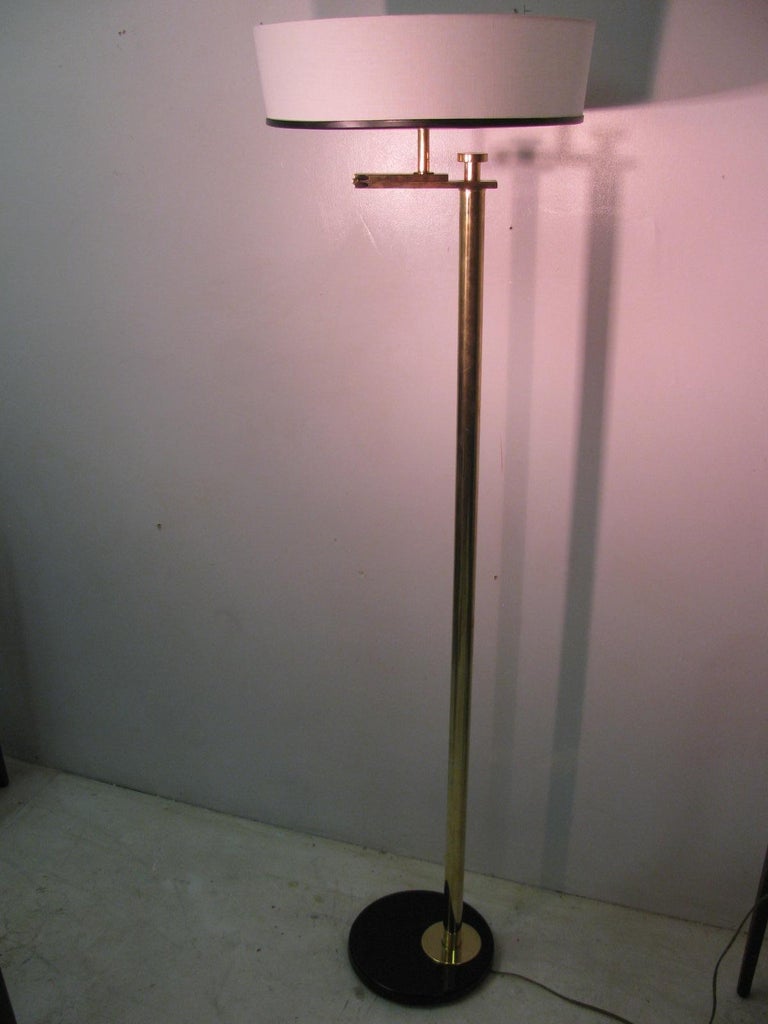 Simple and elegant Flip floor lamp by Kurt Versen. Spectacular design from 1935 where the lamp doubles as a reading lamp and a torchiere. Just flip the shade upward or downward and it looks amazing in either position. Totally restored, all brasses