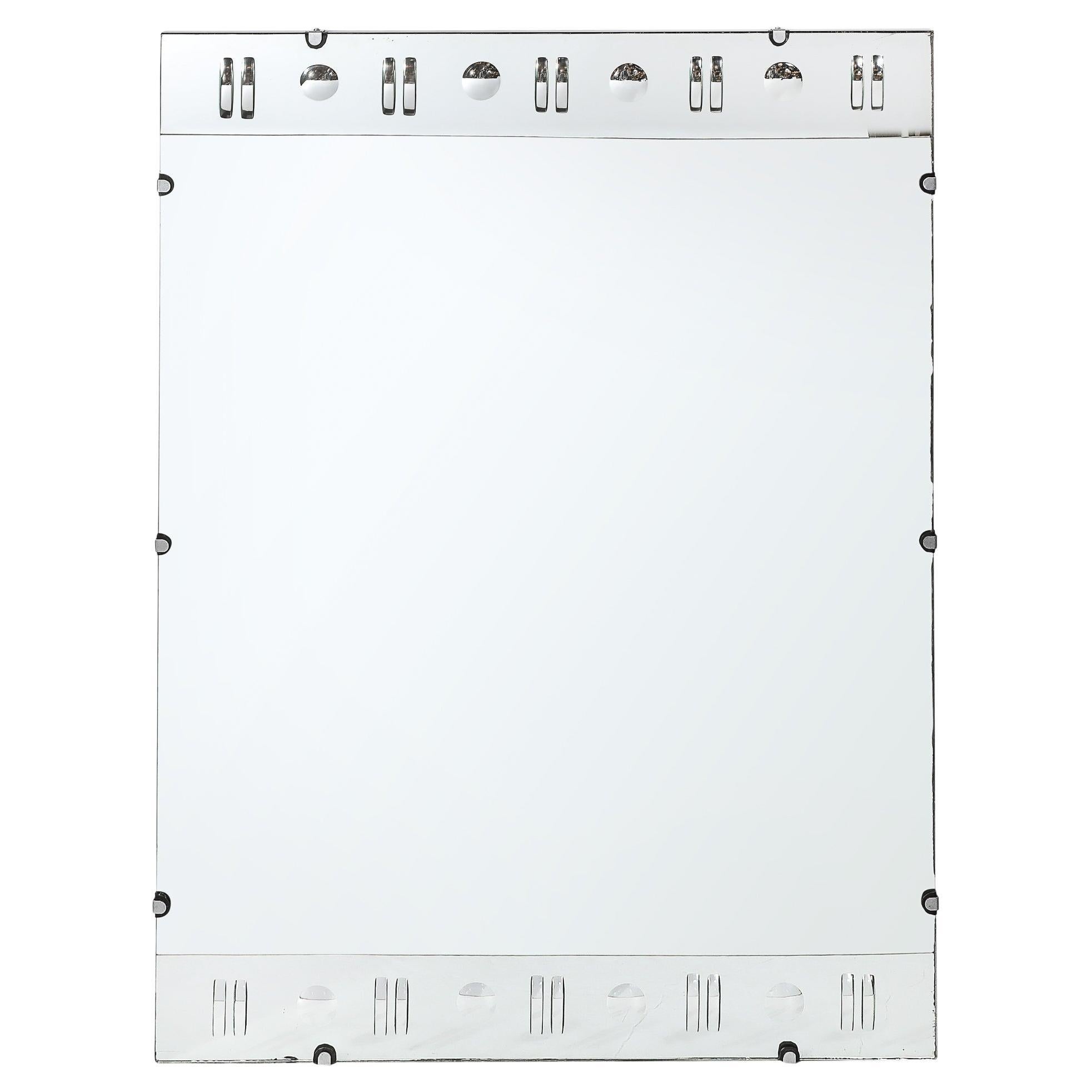 This Art Deco rectangular mirror, crafted in America circa 1935, is a stunning example of the opulent and meticulously detailed design that defines the Art Deco movement. The mirror features reversed etched geometric detailing on the top and bottom