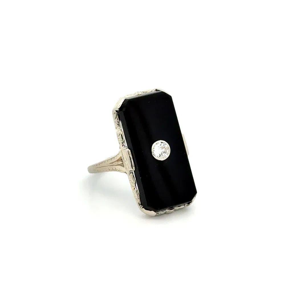 Simply Beautiful! Vintage Art Deco Onyx and Diamond Platinum Filigree Ring. Hand set Onyx Slab, centering a 0.12 Carat Old European Cut Diamond, adding a hint of richness and elegance. The ring is Hand crafted in Platinum. Ring Size 5.25, we offer