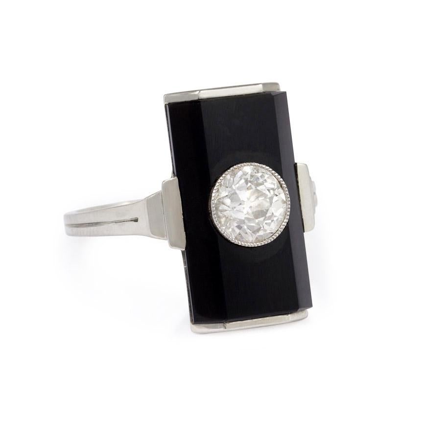An Art Deco ring designed as a rectangular onyx plaque set with an old European-cut diamond, with stepped shoulders, in 18k white gold.  Approximately 0.93 ct. diamond

Plaque measures approximately 18.5mm x 10mm