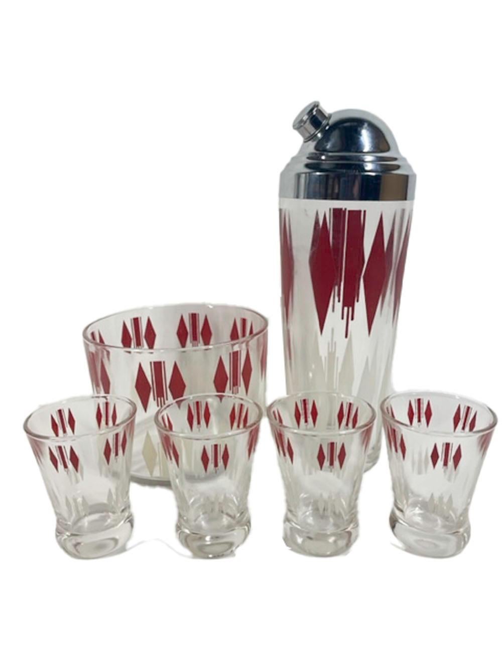 Six-piece Art Deco cocktail set consisting of a cocktail shaker with domed chrome lid, Ice bowl and 4 cocktail glasses. Each piece decorated with red enamel around the top and white enamel around the bottom. Decorated in an Art Deco pattern of