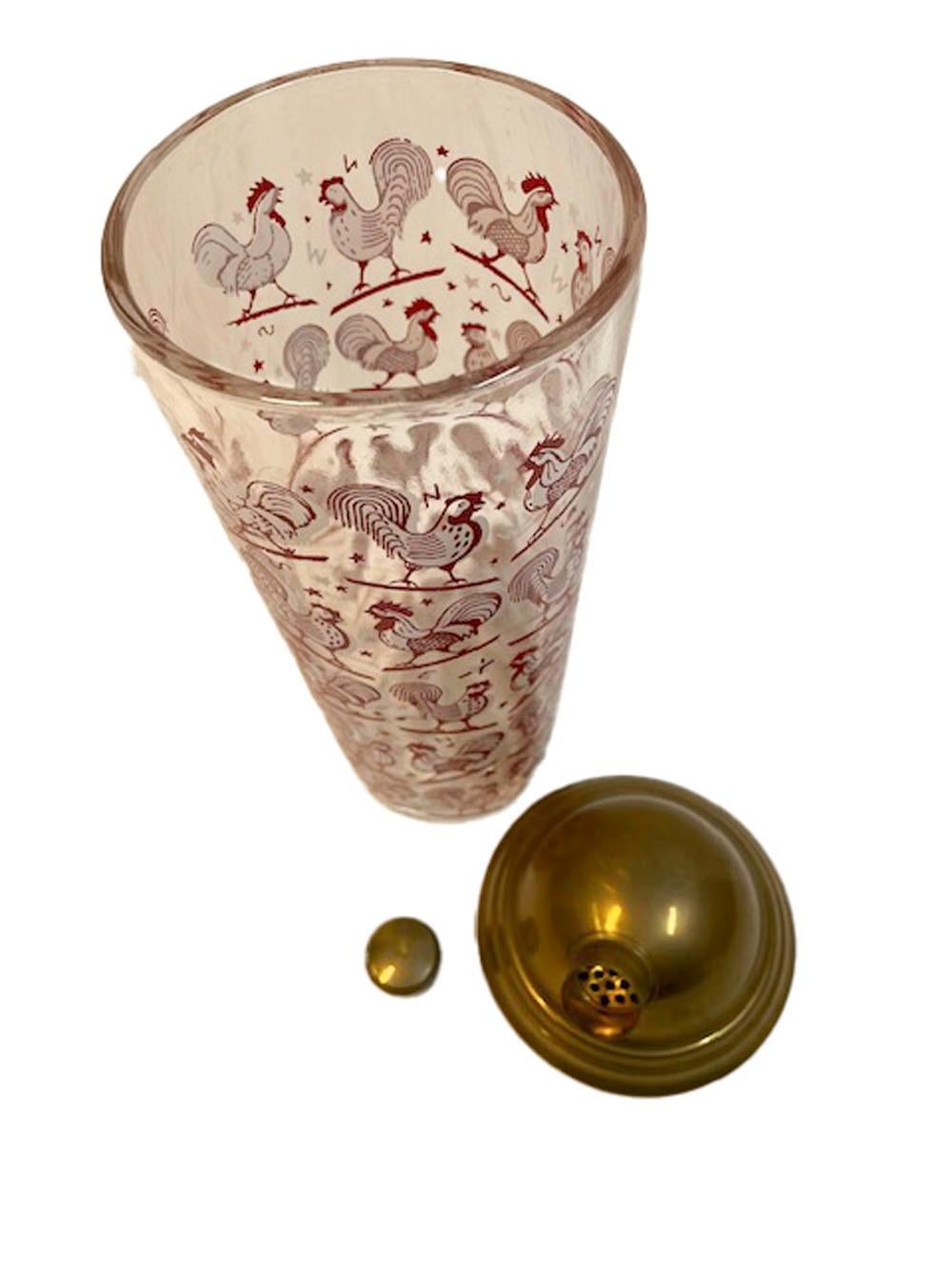 Art Deco cocktail shaker decorated with red and white enamel roosters on clear glass and with a domed gold-tone lid.