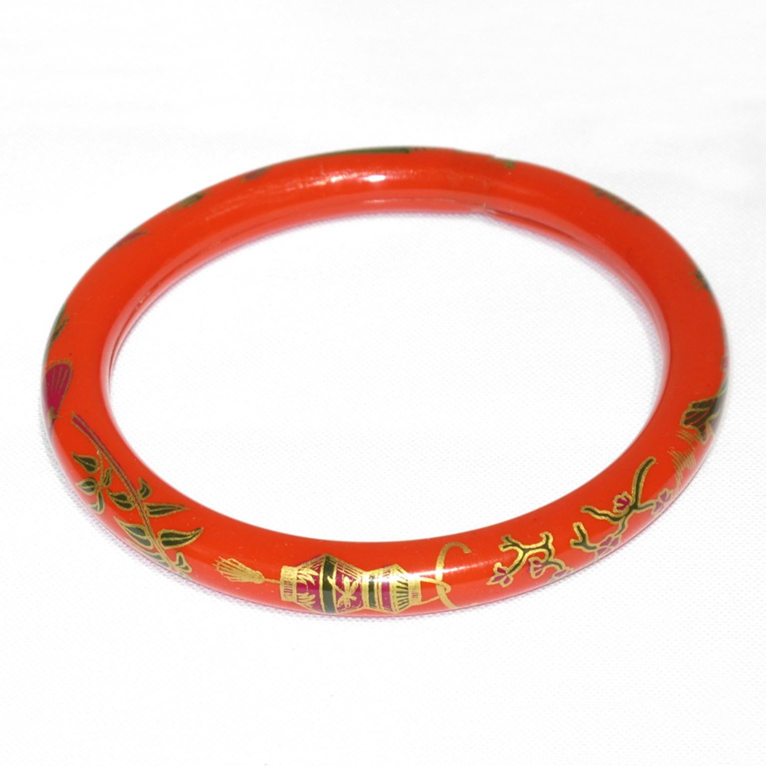 A lovely 1920s French Art Deco celluloid bracelet bangle. It features a light hollow tube shape with an Asian-inspired Japanese design around the bracelet. 
The hollow bracelet technique is an ancient technique applied to jewelry at the turn of the