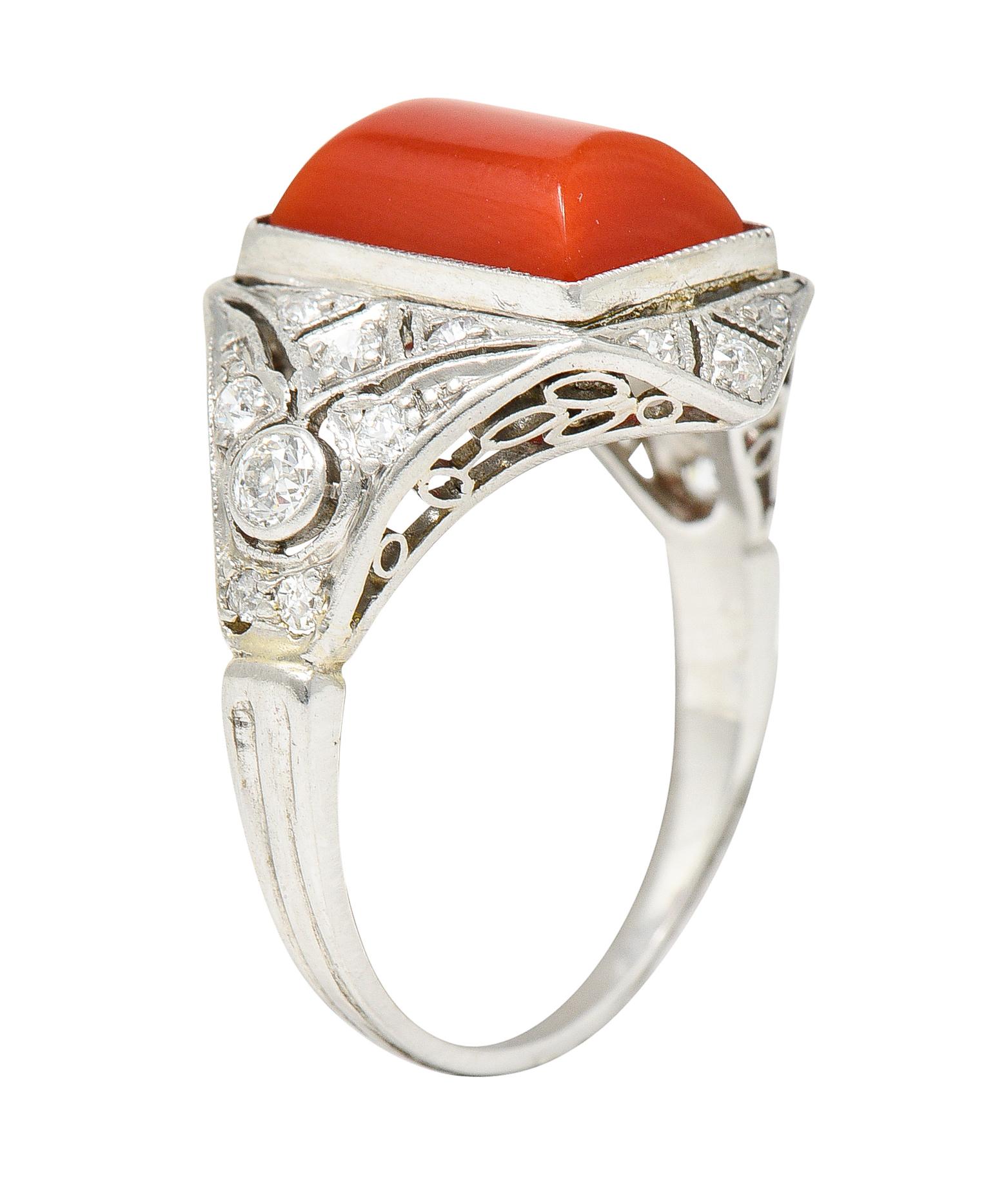 Dynamically formed quatrefoil shaped dinner ring

Centers a barrel cut cabochon of red coral - measuring 10.0 mm x 7.0 mm

Opaque with strong and uniform red color - very good polish

Bezel set and surrounded by old European and old single cut