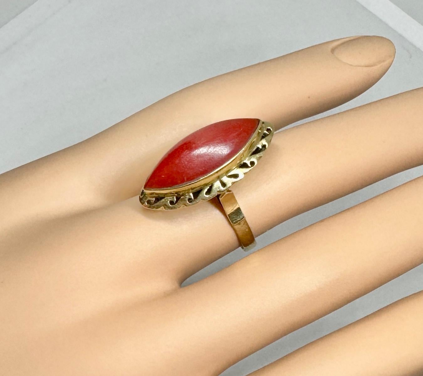 This is a magnificent original antique Art Deco Ring with a beautiful natural Red Coral Cabochon set in a stunning Art Deco design in 14 Karat Gold.  The ring is a masterpiece of the Art Deco period with its dramatic color and style yet very clean