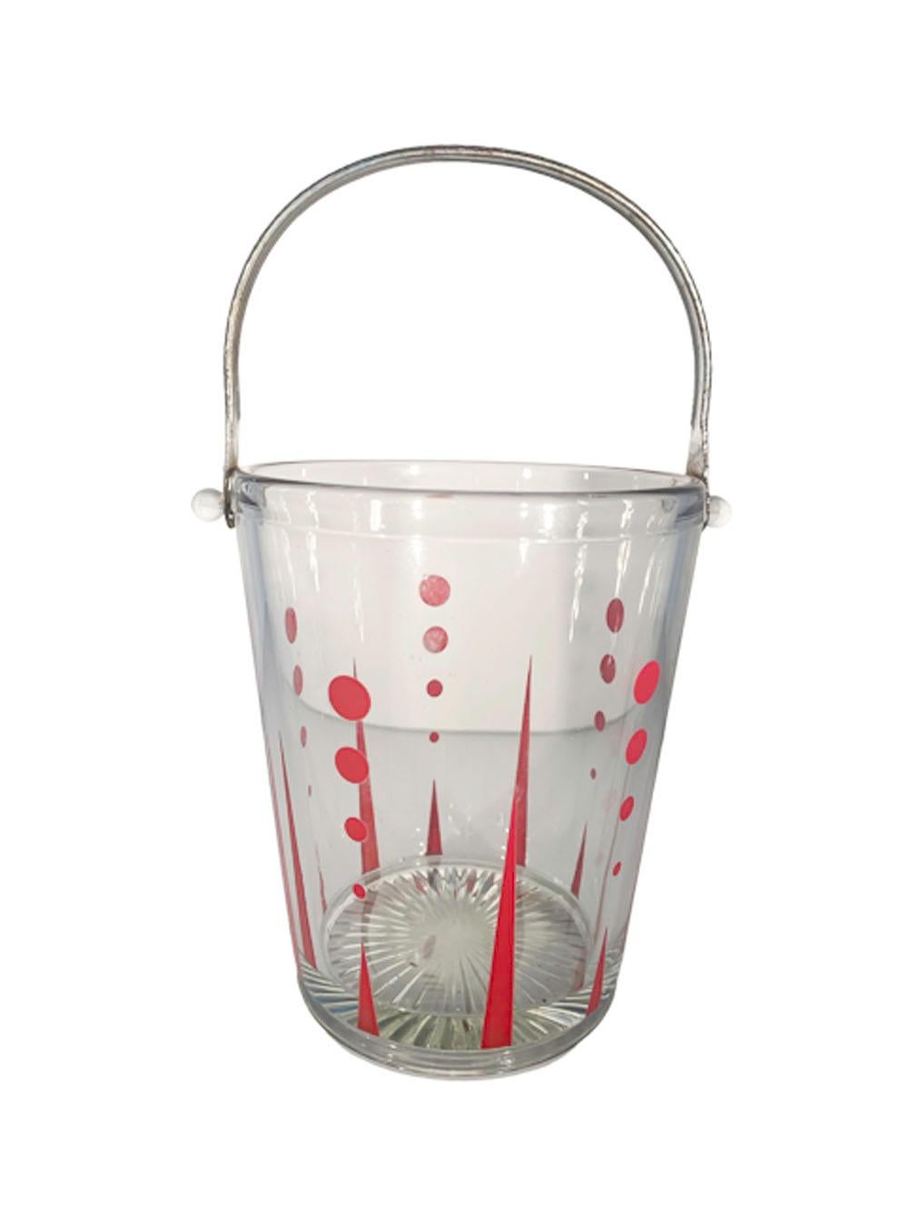 Art Deco bar suite in clear glass with red enamel decoration having long and short arrows pointing up from the bottom below graduated dots getting larger as they go up the side of each piece. The suite consists of a cocktail shaker with aluminum