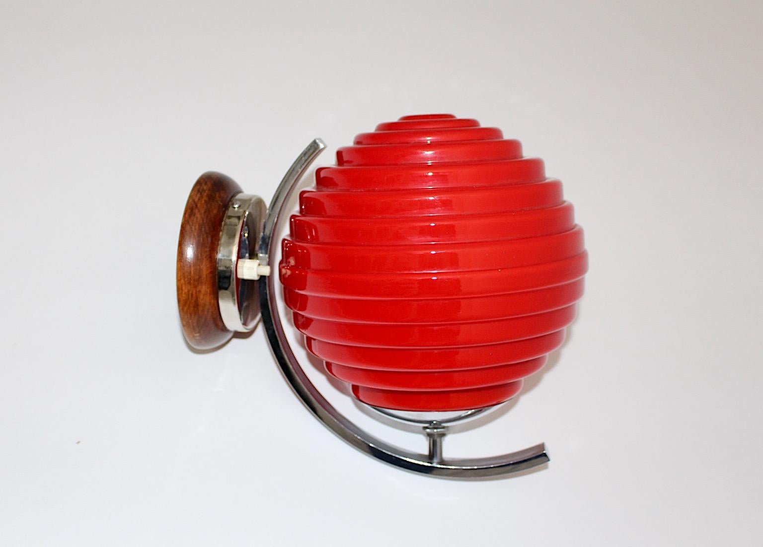 Art Deco vintage sconce or wall lighting lampion lantern like from chromed metal and red glass shade Austria 1920s.
A gorgeous sconce or wall light Japanese lantern - like with a chromed metal fitting and a geometric shape bold red glass shade. The