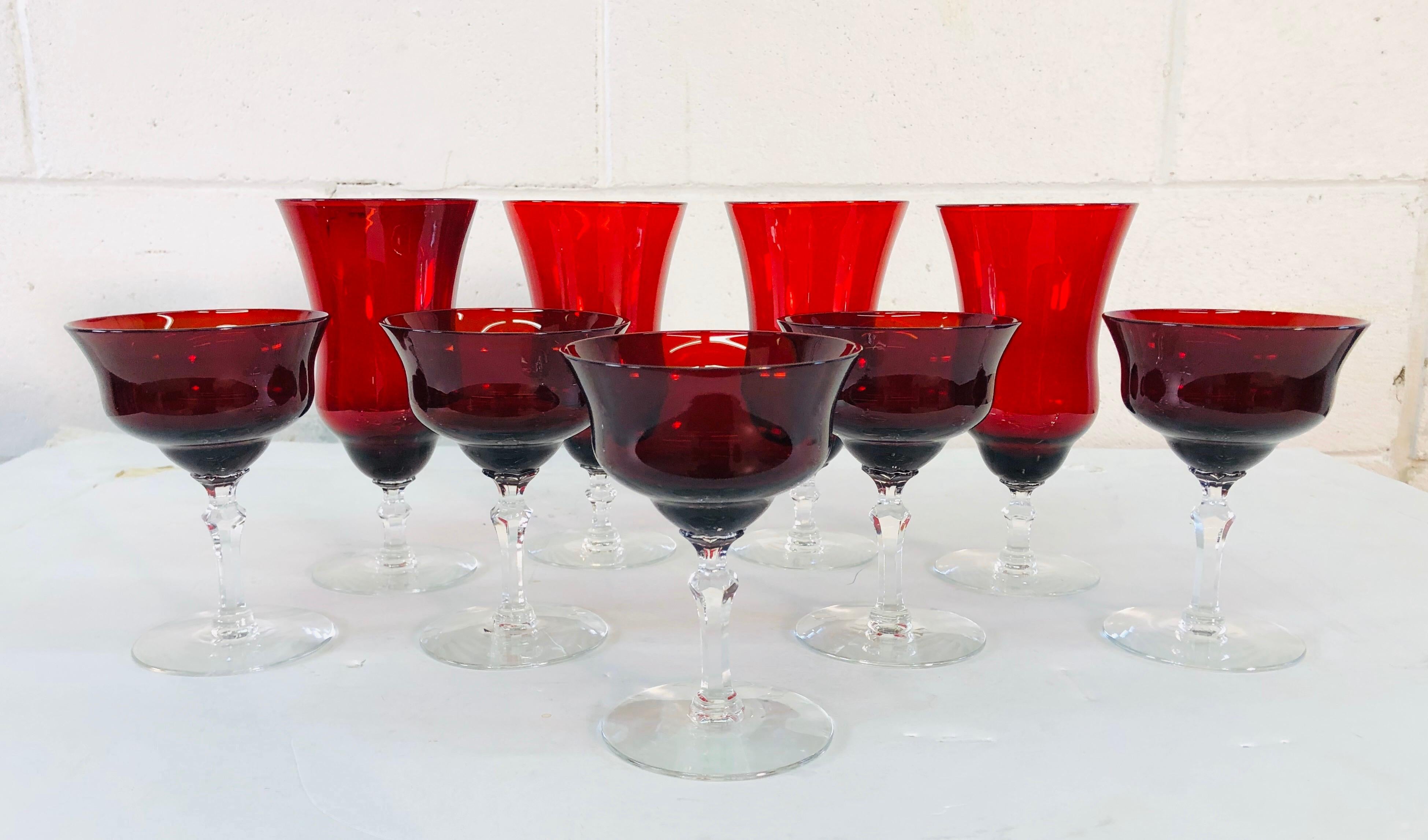 Art Deco set of 9 red glass stems with clear bases. There are 4 water/wine stems that measure 3.5”diameter x 7.75” height. There are 5 coupe stems that measure 3.75” diameter x 5” height. All are in excellent condition. No marks.