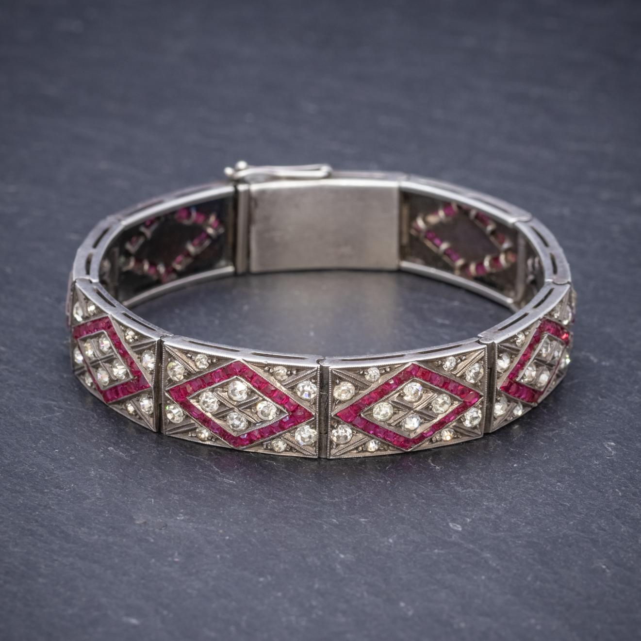 A stunning articulated Art Deco bracelet decorated with sparkling red and white Paste Stones which are set out in a lovely patterned design and together resemble Rubies and Diamonds. 

The piece is substantial all modelled in Silver with secure box