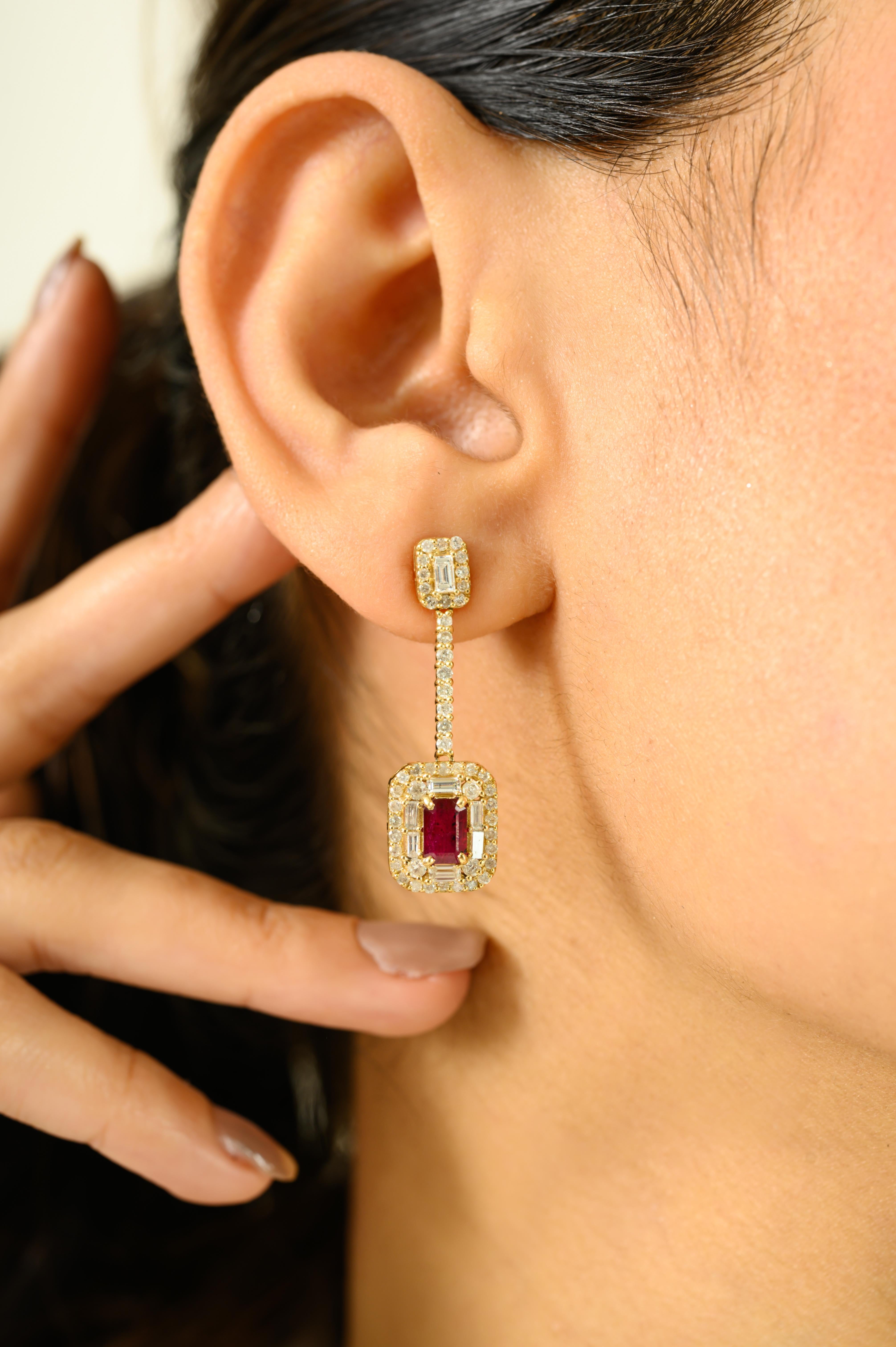 Crafted in radiant 14K yellow gold, these exquisite drop earrings showcase timeless elegance with a modern twist. Each earring features a rich, emerald-cut ruby gemstone (total stone weight: 0.83 carats) set at the center, framed by a dazzling halo