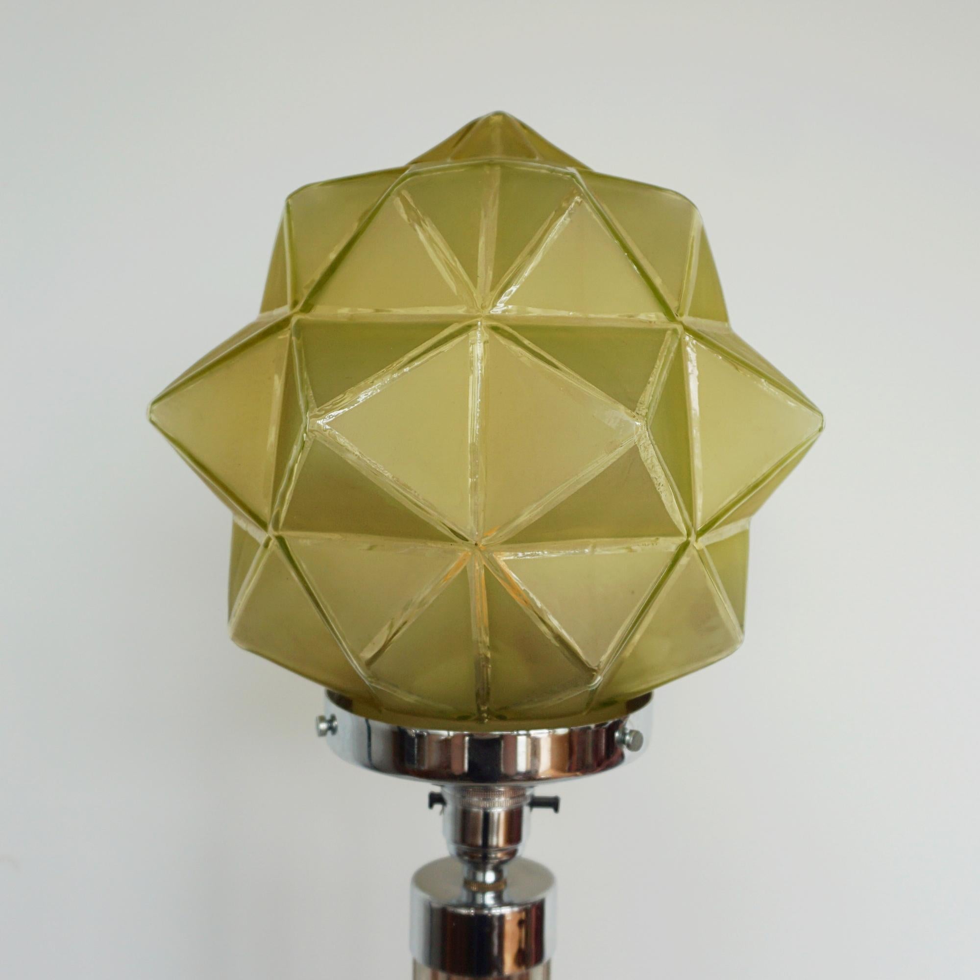 An Art Deco table lamp. reeded glass stem with a walnut and chromed metal base. Yellow spiked glass shade. 