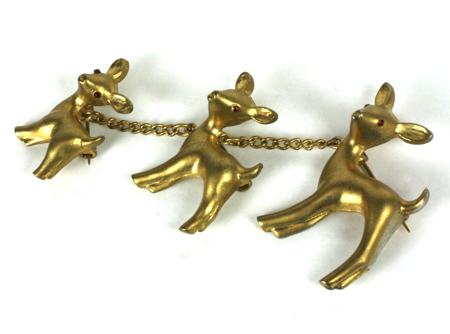 Charming Gold toned Chanel Multi Deer Brooch from the 1930's. Entire deer family is attached by chains, each with its own pin fitting and ruby crystal eyes. 
Although this is NOT a creation or design from the house of Chanel, Paris, this licensed
