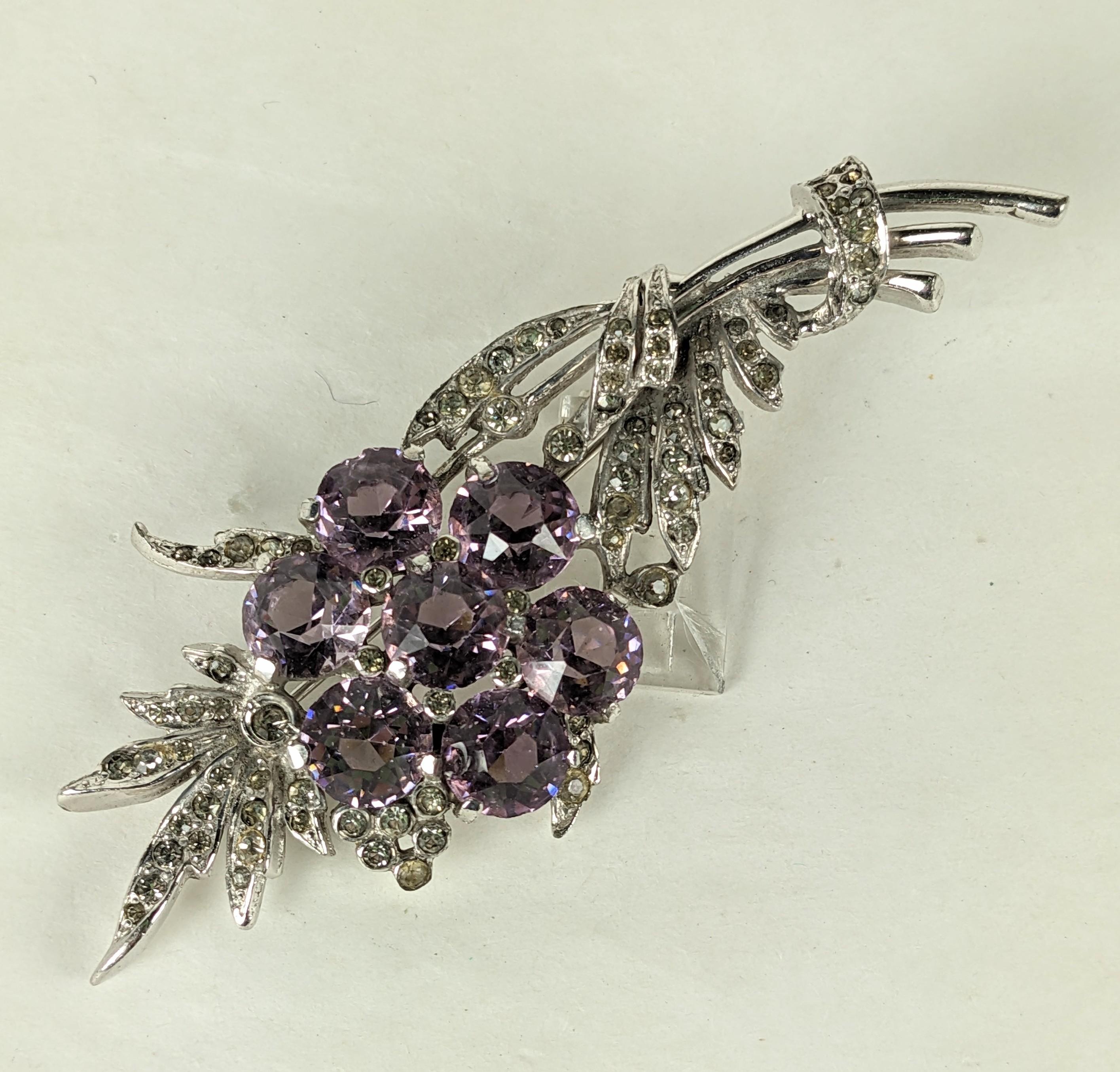 Deco Reja Pave Flower Spray with lilac colored pastes set within a pave design in high rhodium finish. 1930's USA. Unsigned. 3.75