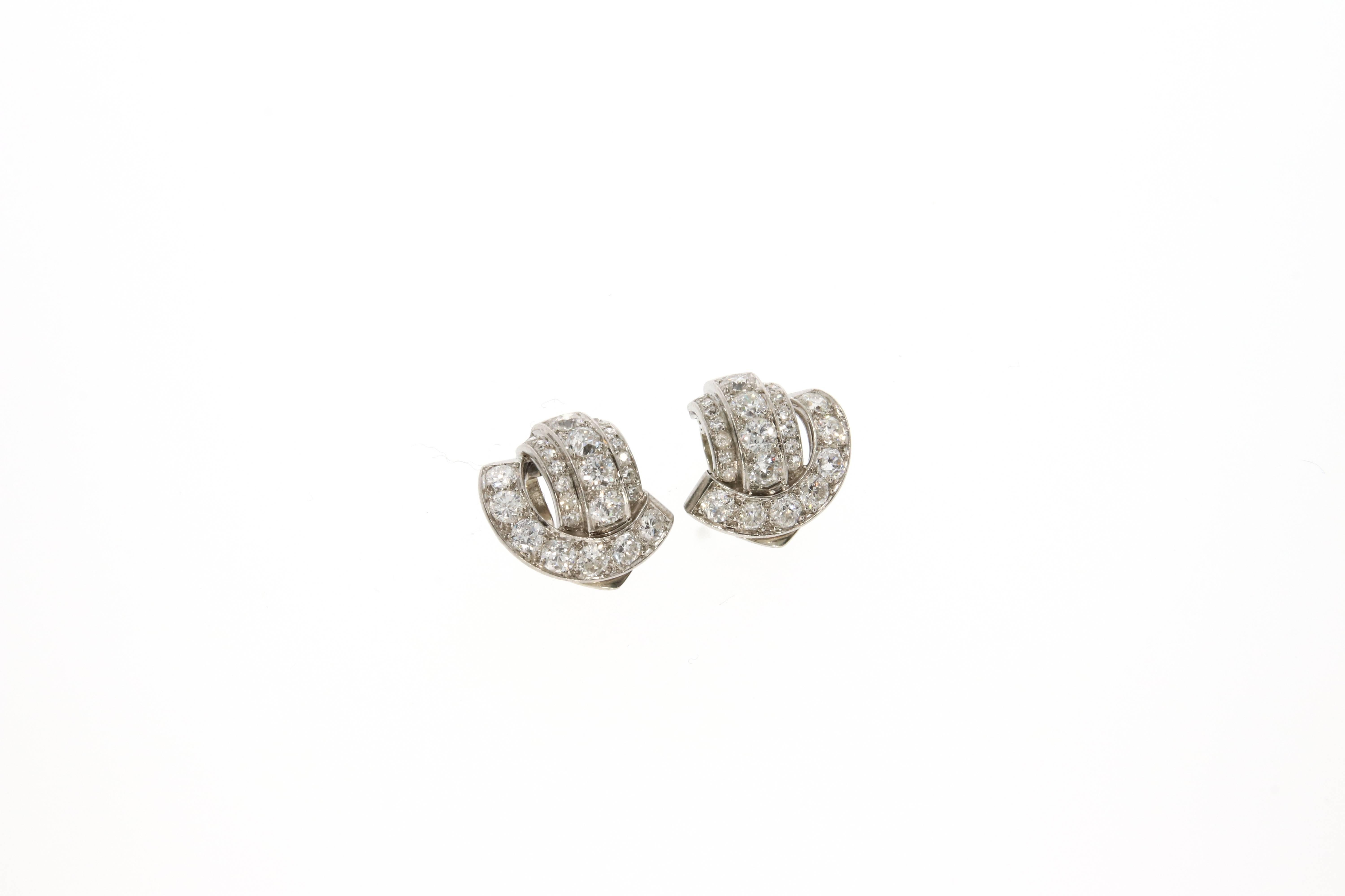 A beautiful pair of platinum set diamond earclips, by Boivin. The curved settings are embedded with 50 old mine cut diamonds weighing approximately 3.30 carats in total. French hallmarks for 18 karat gold and platinum and maker´s mark are stamped on