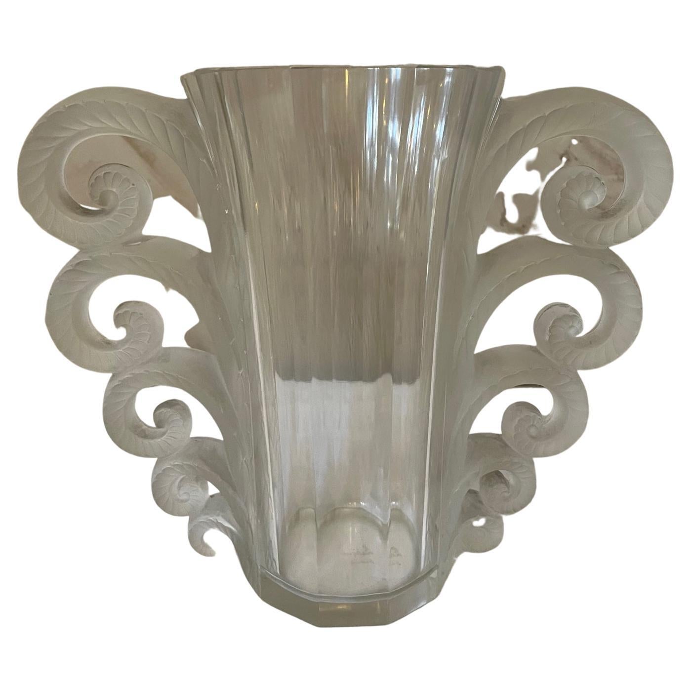 Beautiful 20th century René Lalique Beauvais vase made with a tall clear glass flaring form with five graduating scrolling handle forms on each side. 
Stamped Lalique France at the back. 
Exceptional quality and condition.