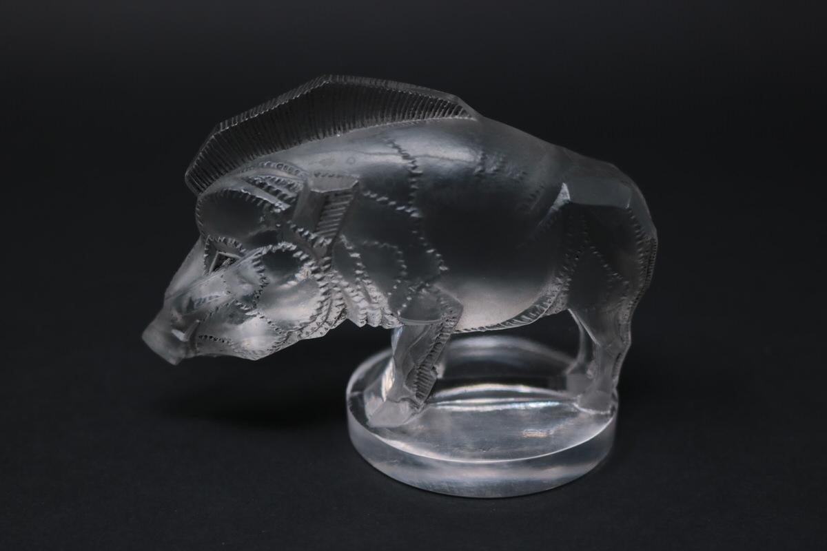 René Lalique clear and frosted with grey staining glass 'Sanglier' Mascot. Features a wild boar. Moulded & Stenciled makers mark, 'R LALIQUE FRANCE'. Book reference: Marcilhac 1157.