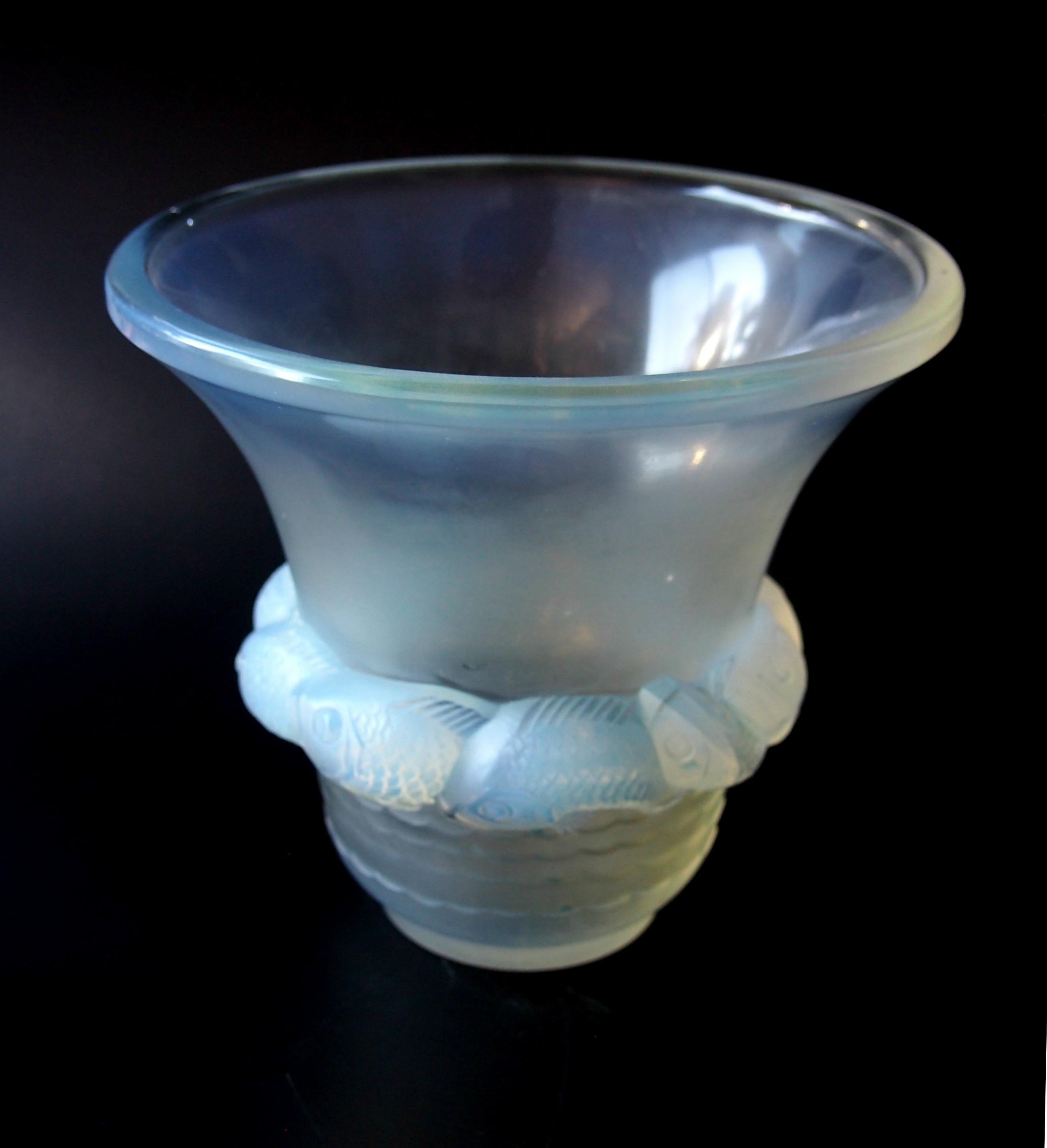 Rare strong opalescent Art Deco Rene Lalique signed 'Piriac' vase depicting stylised fish. Dating from 1930. (Ref: Marcilhac 1043). 

This is one of the finest and rarest of his opalescent Art Deco vases the opalescence is excellent with blues