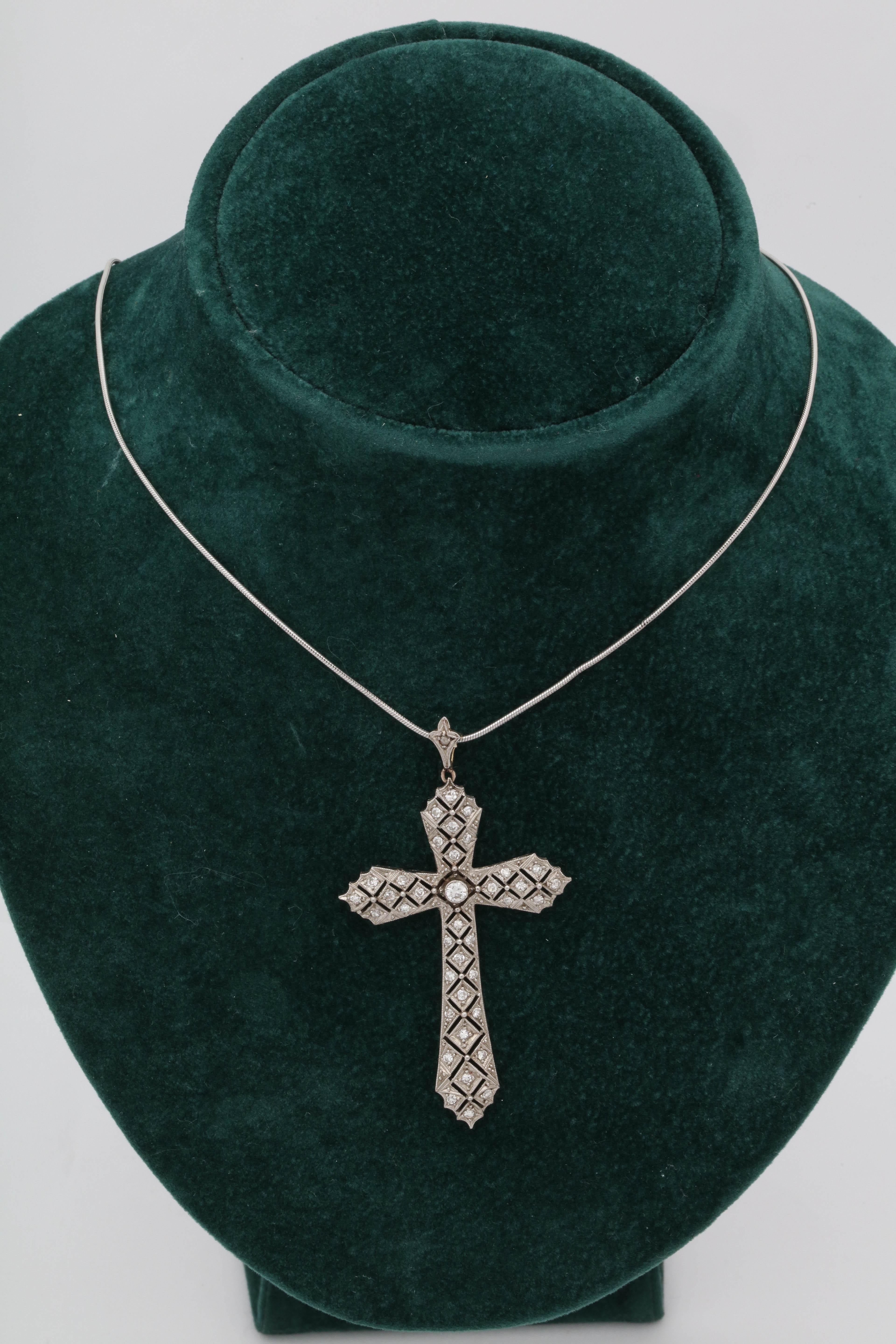 One Ladies Antique Art Deco Open Pierced Workmanship Diamond Cross Pendant Handmade In The United States Of America. Handmade Platinum And 18kt Gold Bail With Diamonds Attached To Top Of Cross. Created in the 1920's.Aproximate Diamond Weight 1.5 Cts.